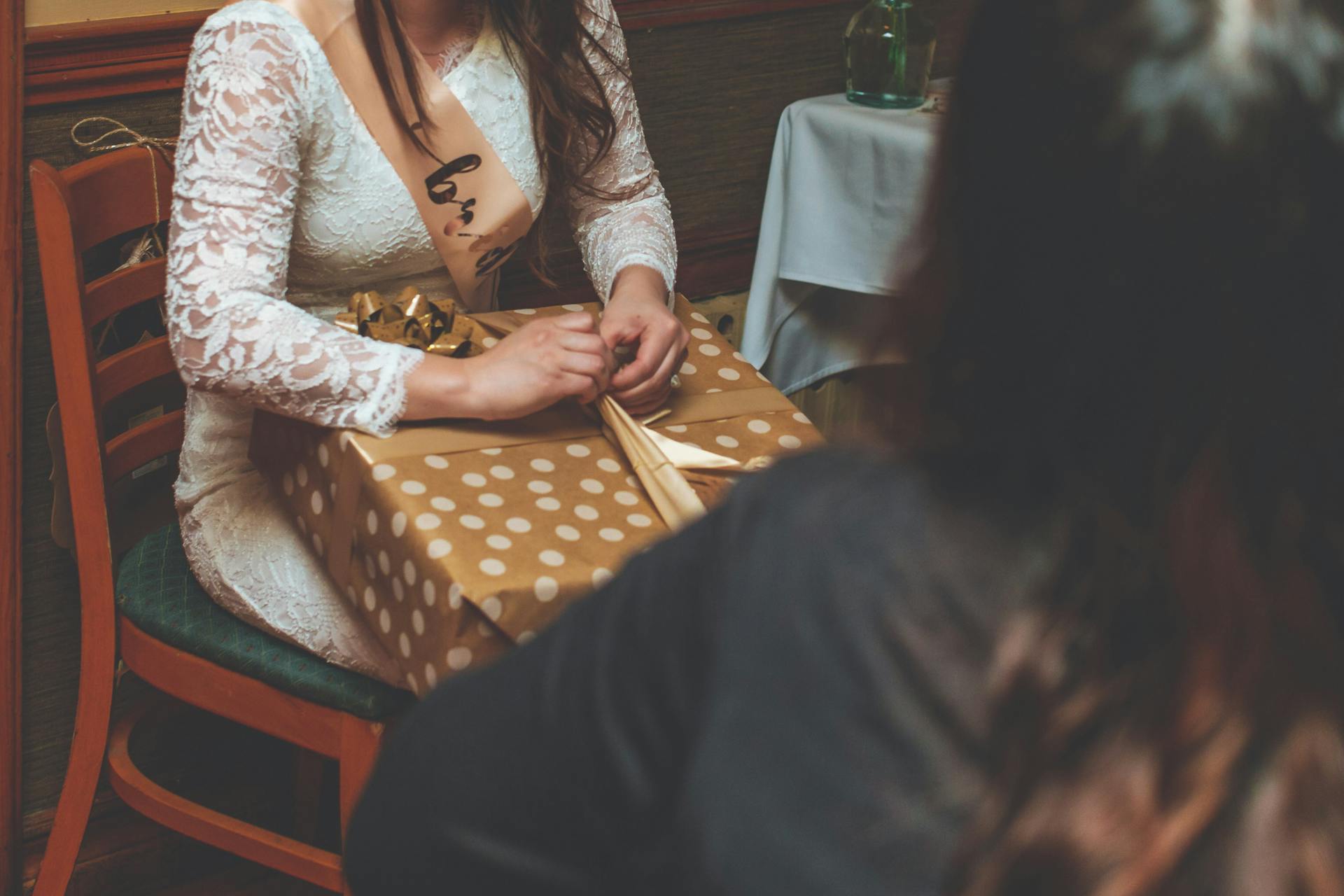 A woman unwrapping her birthday gift | Source: Pexels