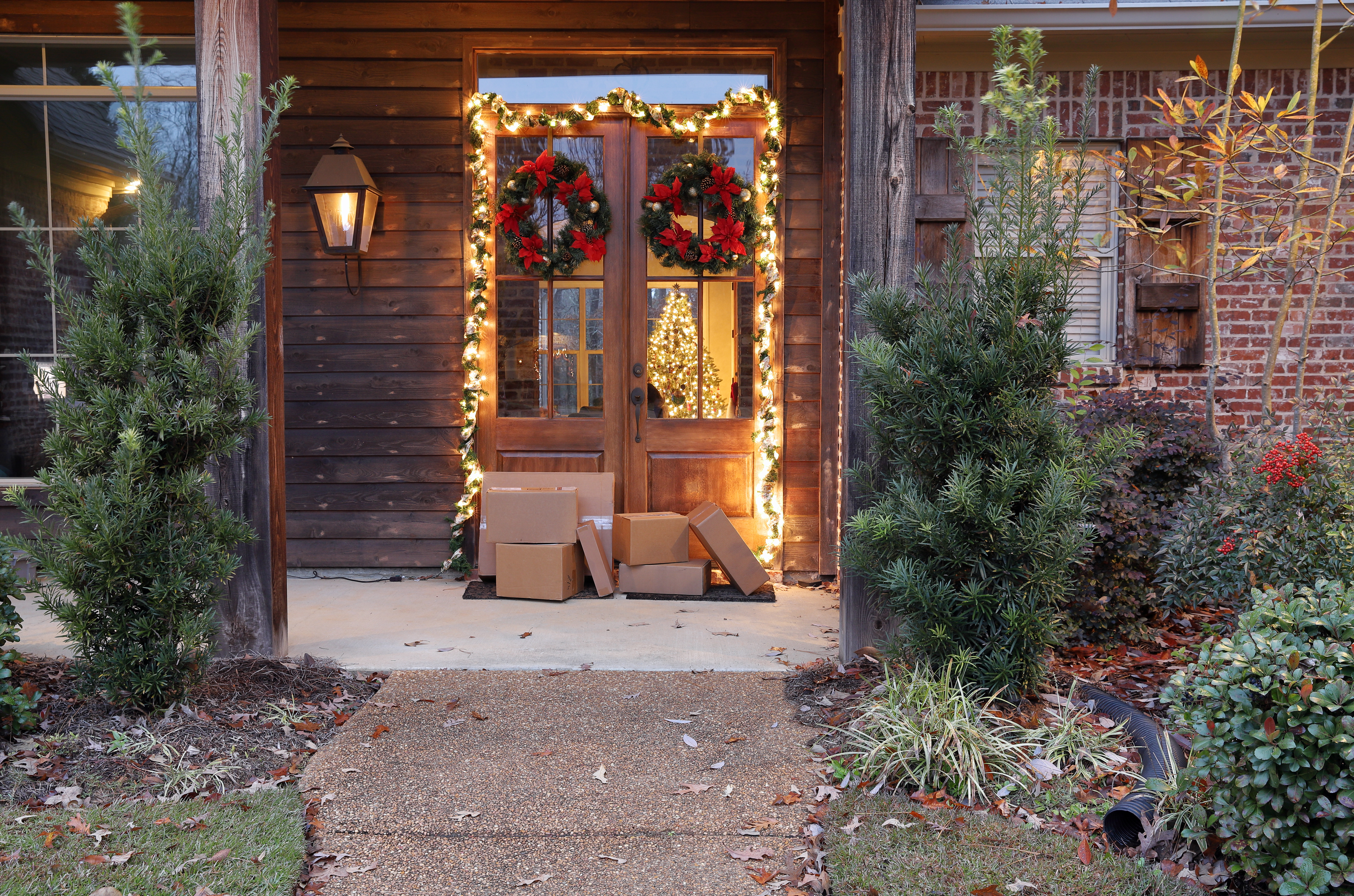 Boxes and packages placed next to front door during Christmastime | Source: Shutterstock
