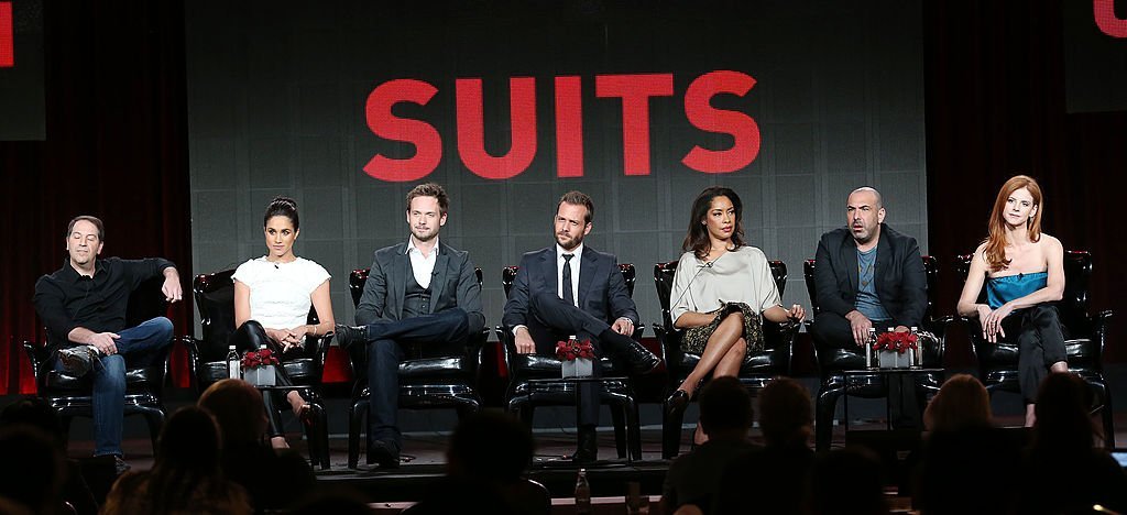 Executive producer Aaron Korsh, actress Meghan Markle, actor Patrick J. Adams, actor Gabriel Macht, actress Gina Torres, actor Rick Hoffman, and actress Sarah Rafferty of the television show "Suits" speak during the 2014 Winter Television Critics Association Press Tour | Photo: Getty Images