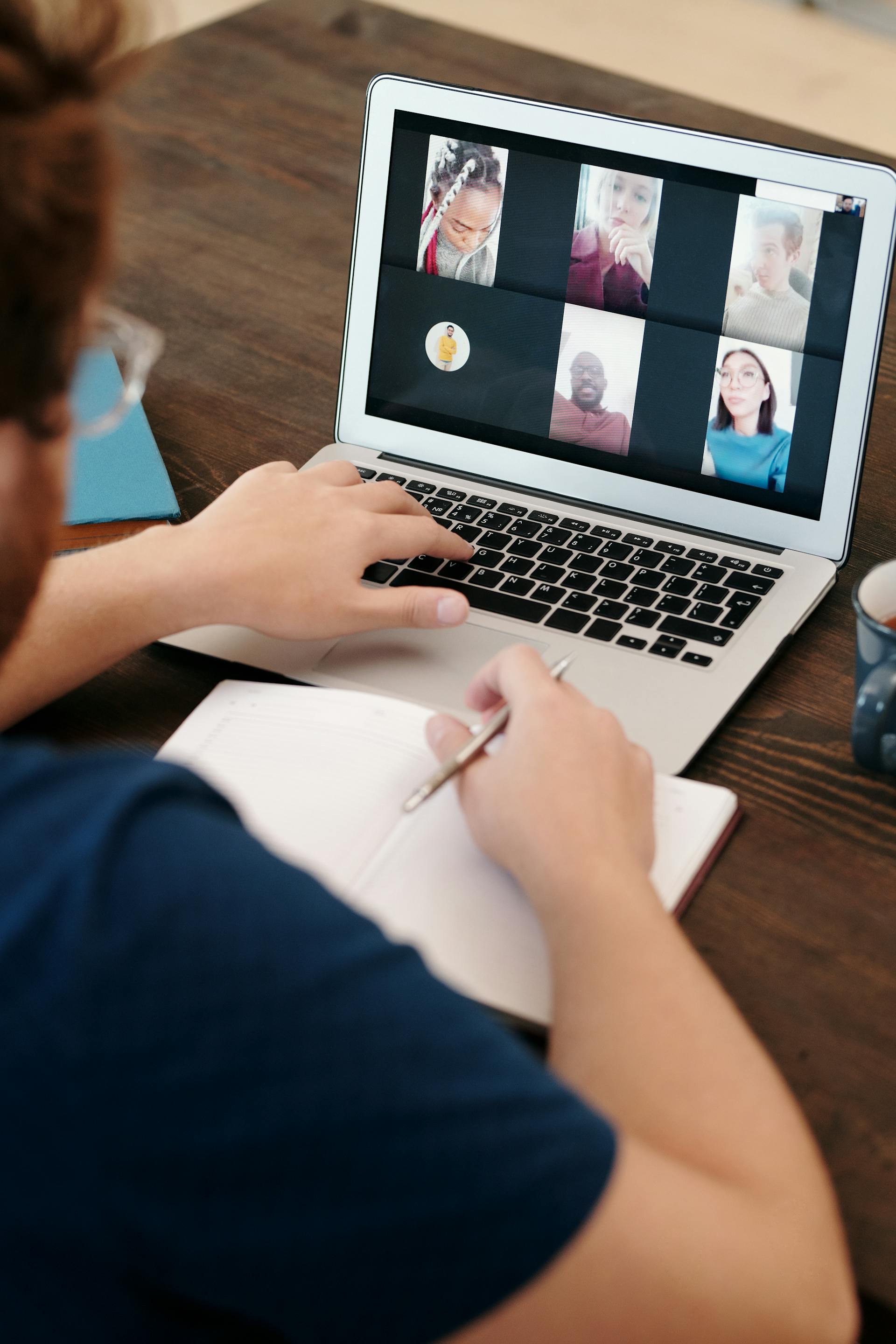 A close-up of a man having a virtual meeting with his work colleagues | Source: Pexels