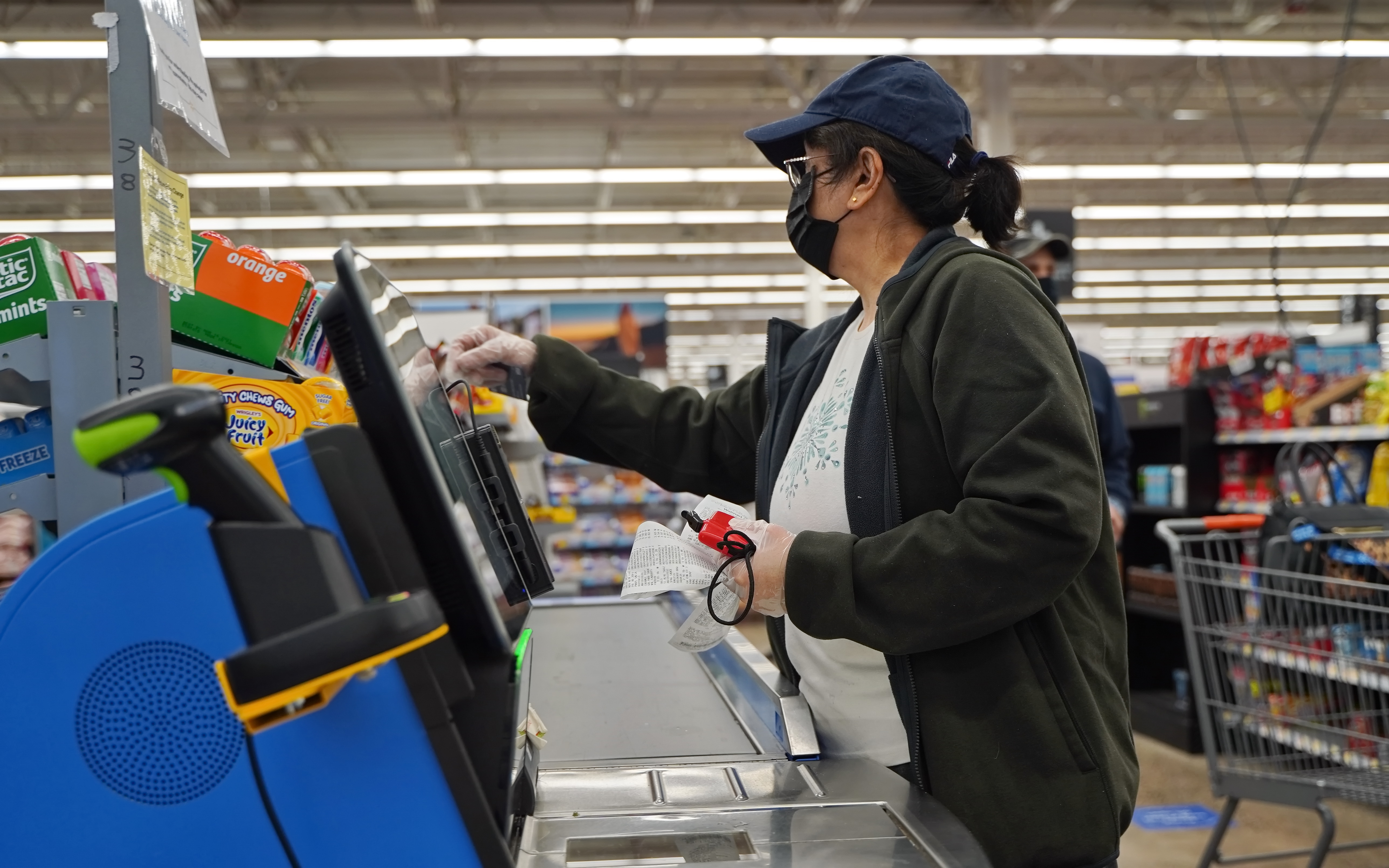 A woman at a self-checkout station | Source: Shutterstock