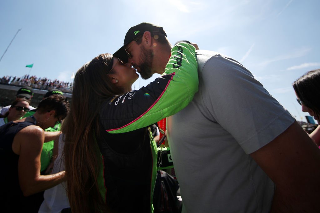 Danica Patrick, driver of the #13 GoDaddy Chevrolet kisses Aaron Rodgers prior to the 102nd Running of the Indianapolis 500 at Indianapolis Motorspeedway on May 27, 2018 in Indianapolis, Indiana. | Source: Getty Images