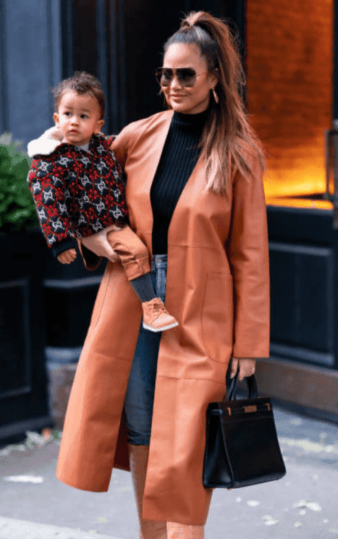 Chrissy Teigen carrying her son, Miles Stephens as she exists from SoHo with her family, on November 23, 2019, in New York City | Source: Getty Images (Photo by Gotham/GC Images)