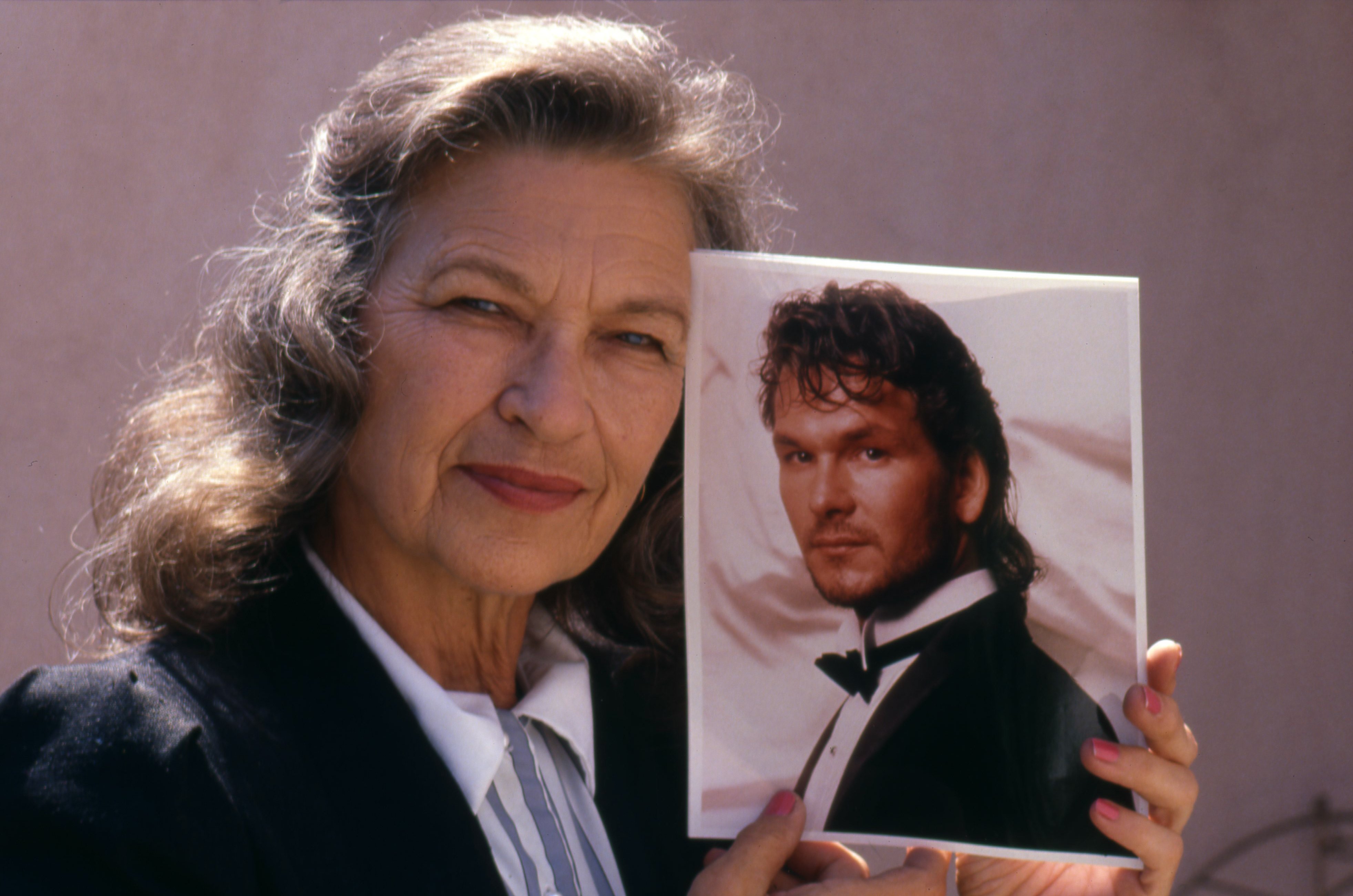 Portrait of Patsy Swayze with a picture of Patrick Swayze circa 1988 | Source: Getty Images