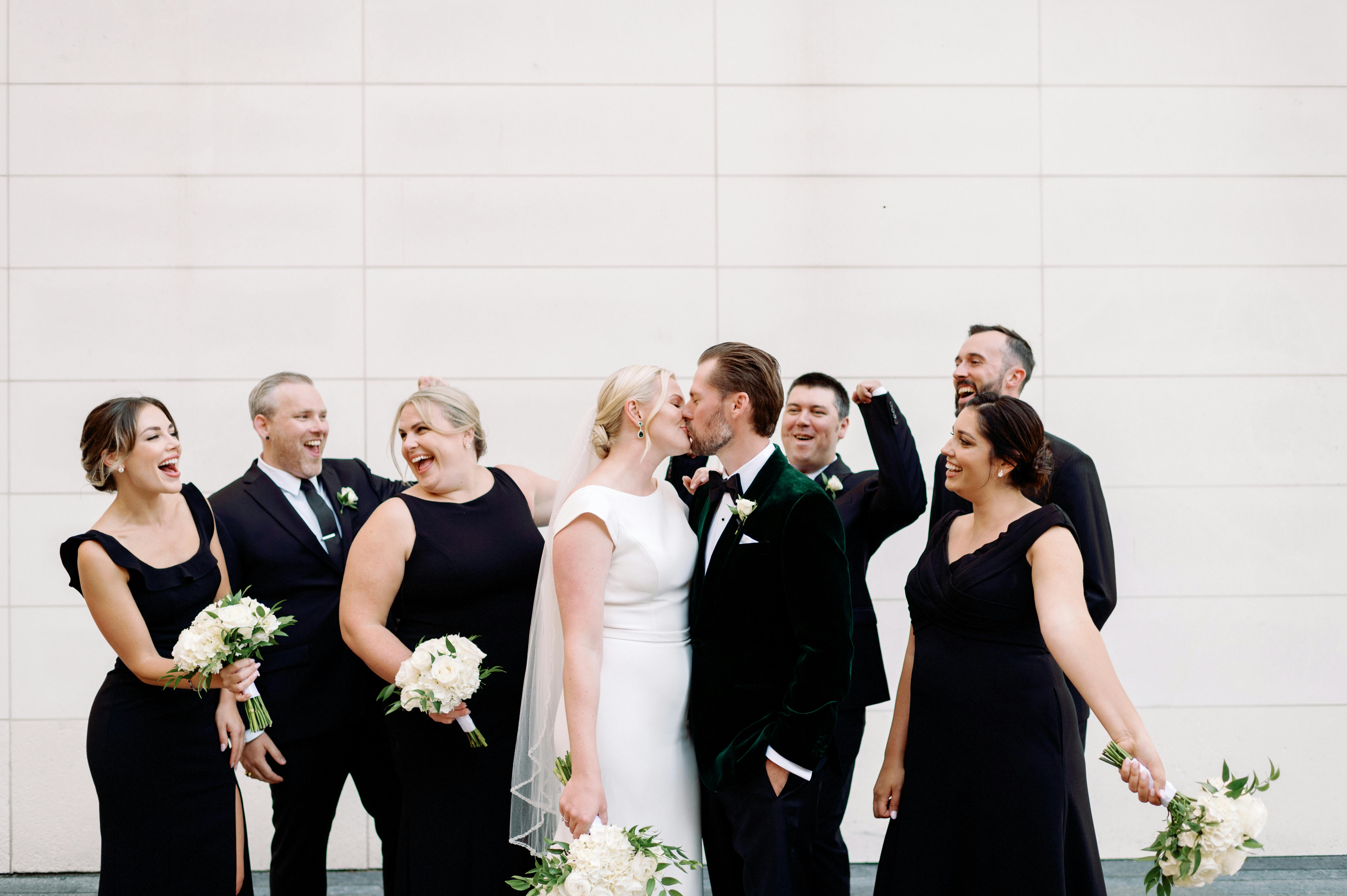 Bride and groom kissing in front of guests | Source: Pexels