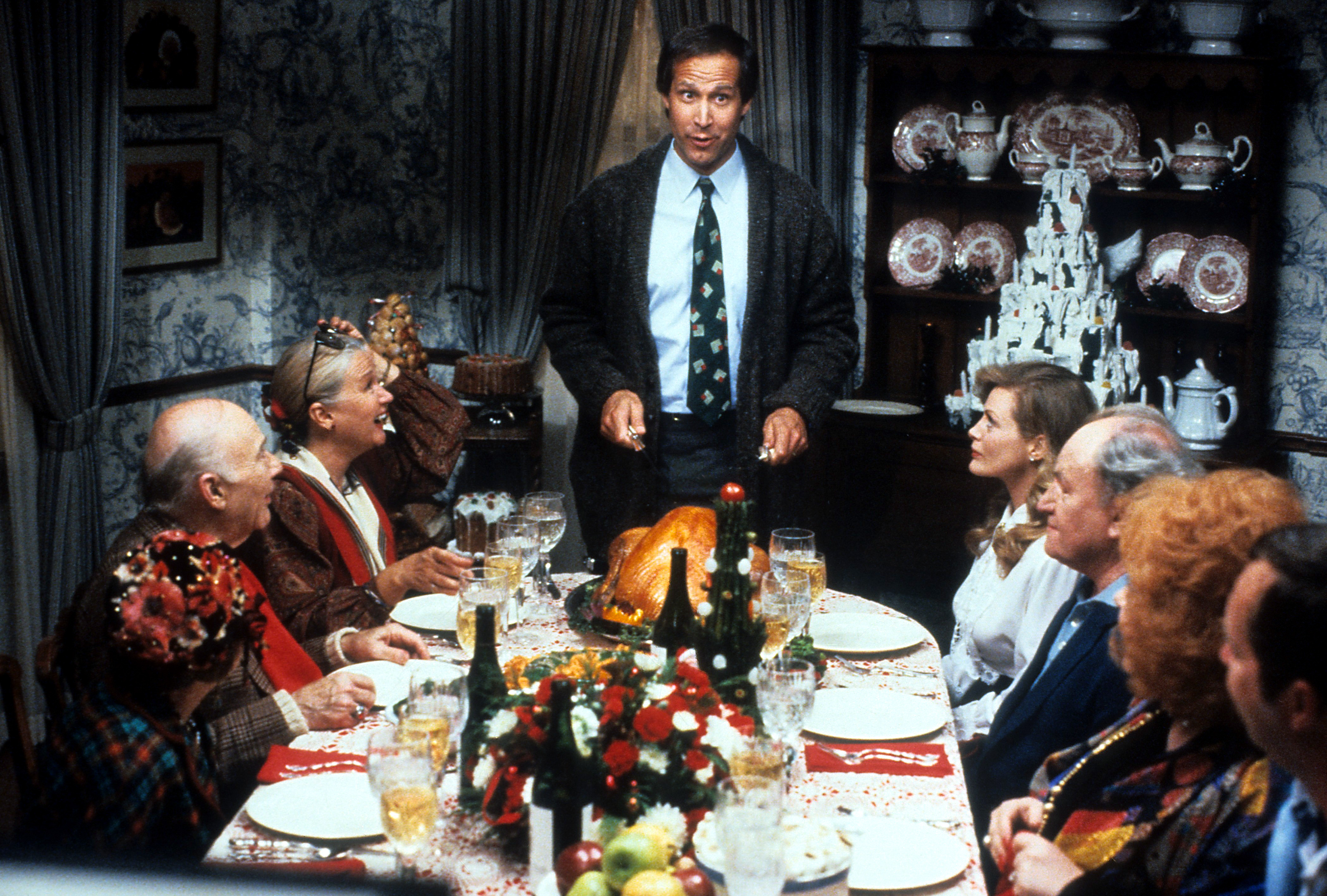 Chevy Chase stands at the head of the table in a scene from the film "National Lampoon's Christmas Vacation" in 1989. | Source: Getty Images