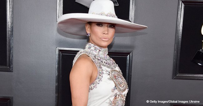 Jennifer Lopez wows wearing a deep back-slit dress and an enormous hat for the Grammy's