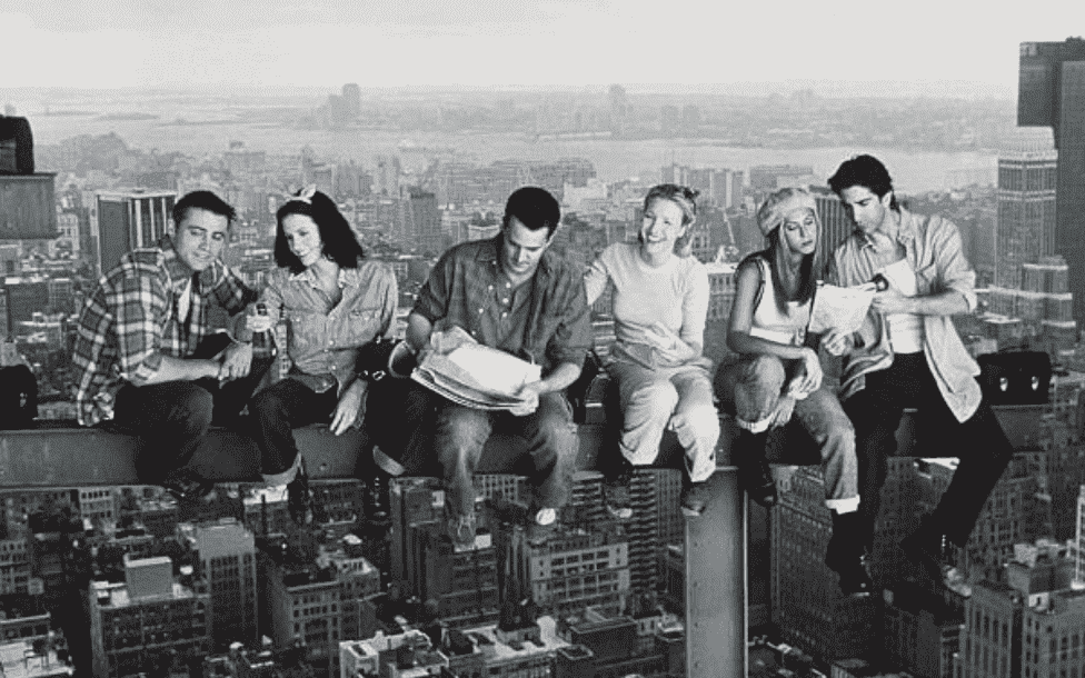 Matthew Perry, Jennifer Aniston, Courteney Cox, Matt Le Blanc, Lisa Kudrow, And David Schwimmer sit along a steel railing as construction workers for promotional advertisements for "Friends," on January 01, 1999 | Source: Getty Images