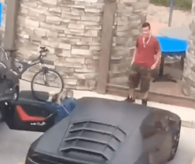 Man who pretended a Lamborghini belonged to him smiles slightly when he realizes that he was found out | Photo: TikTok/babyjayb