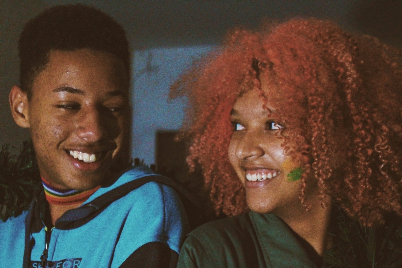 Photo of teenage couple smiling. | Source: Pexels/Raphael Brasileiro