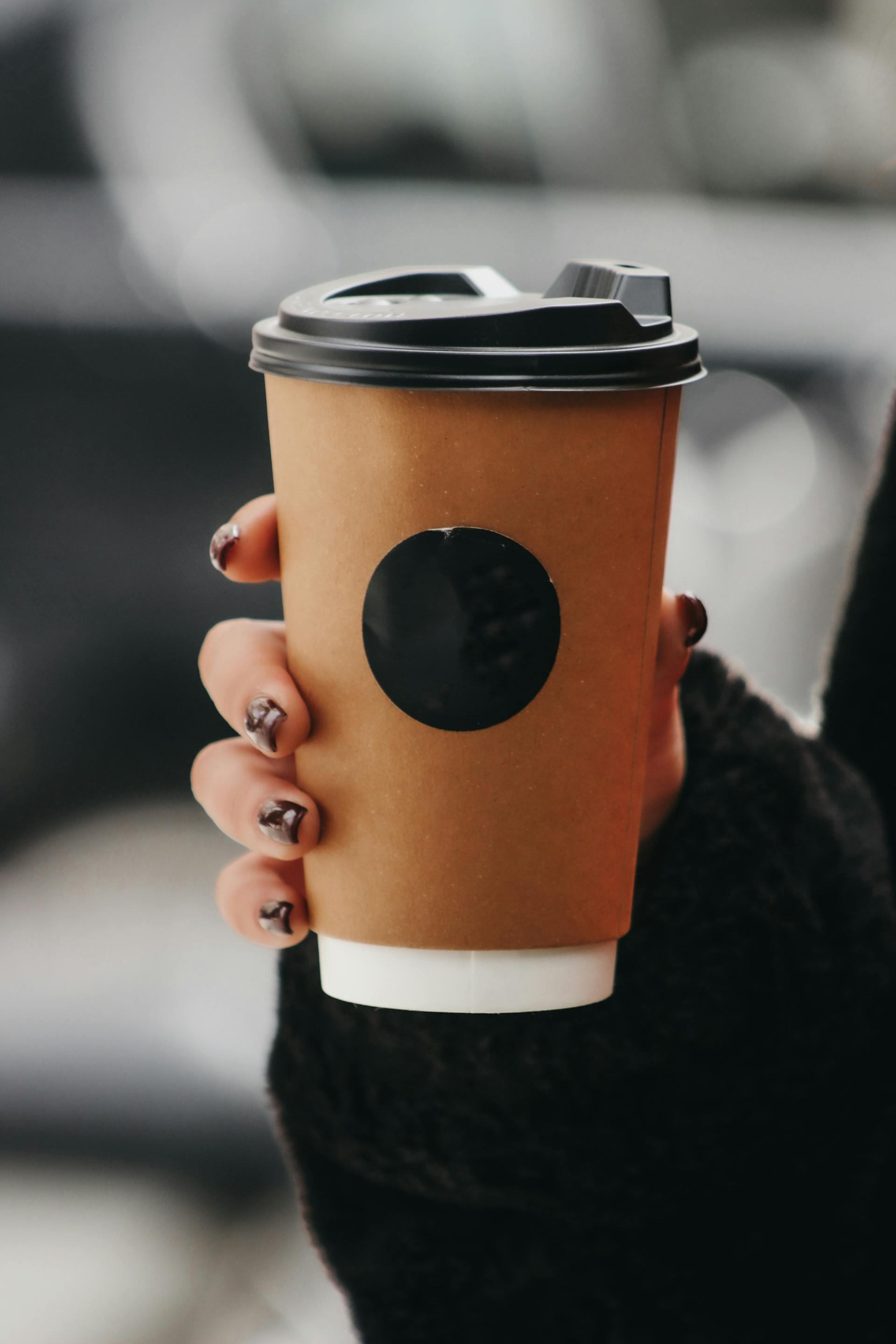 Close-up shot of a woman holding coffee | Source: Pexels