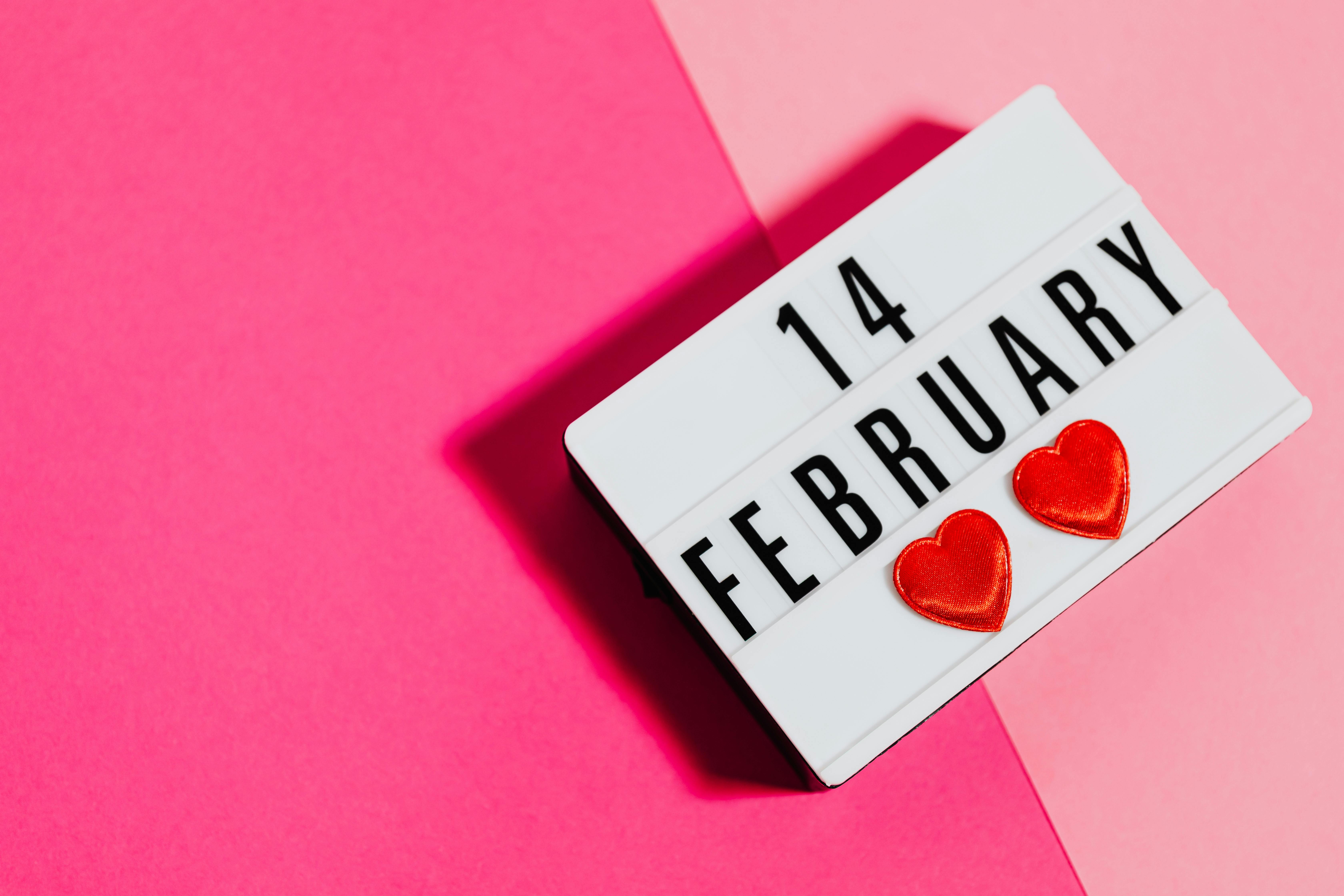 A light up message board with written February 14 on a Pink Background | Source: Pexels