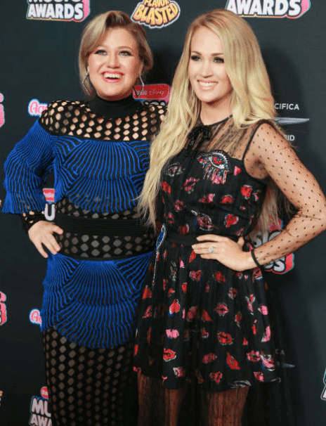 Kelly Clarkson and Carrie Underwood pose together on the red carpet at the Radio Disney Music Awards, at Loews Hollywood Hotel, on June 22, 2018, California | Source: Getty Images