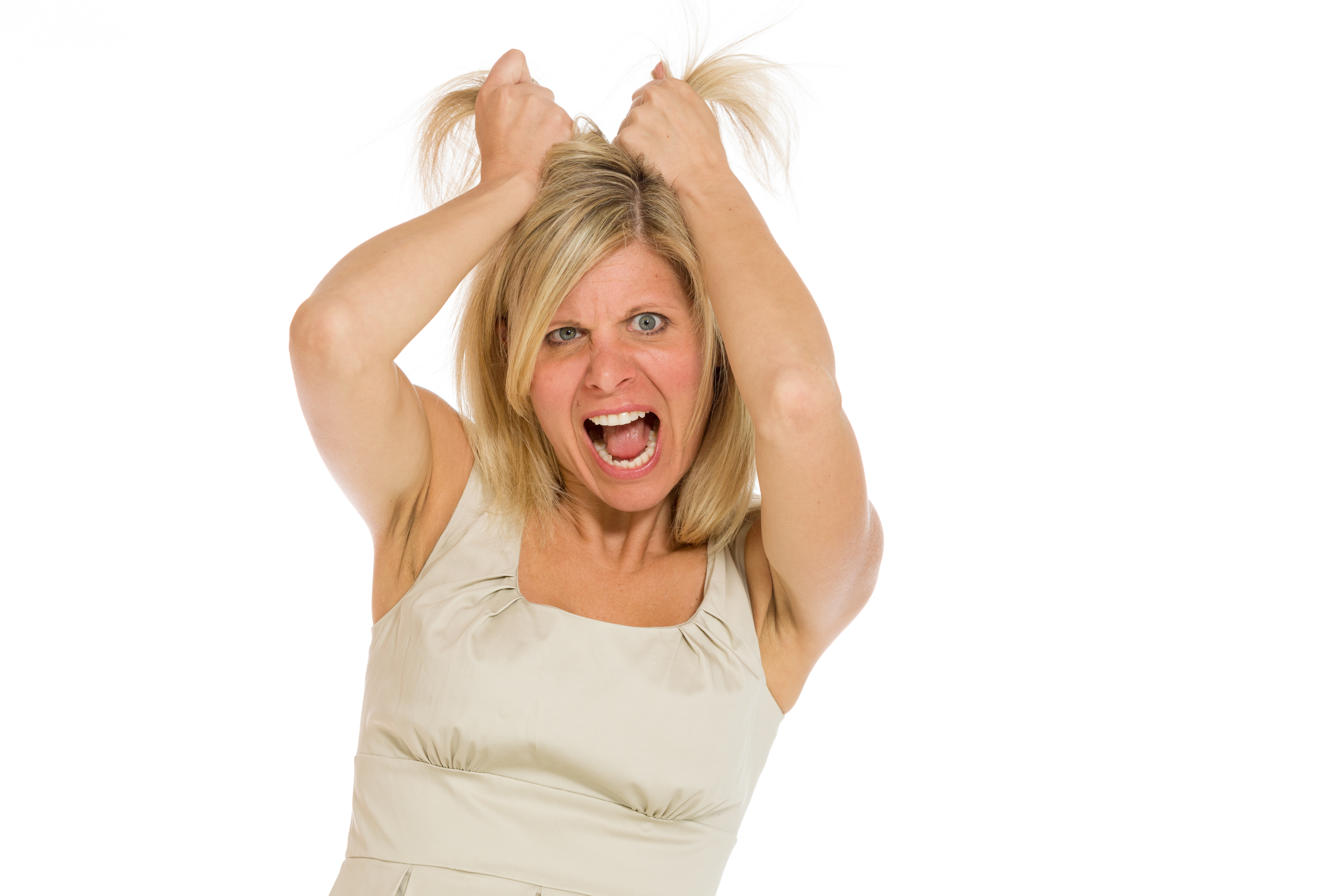 An angry woman pulling her hair | Source: Shutterstock
