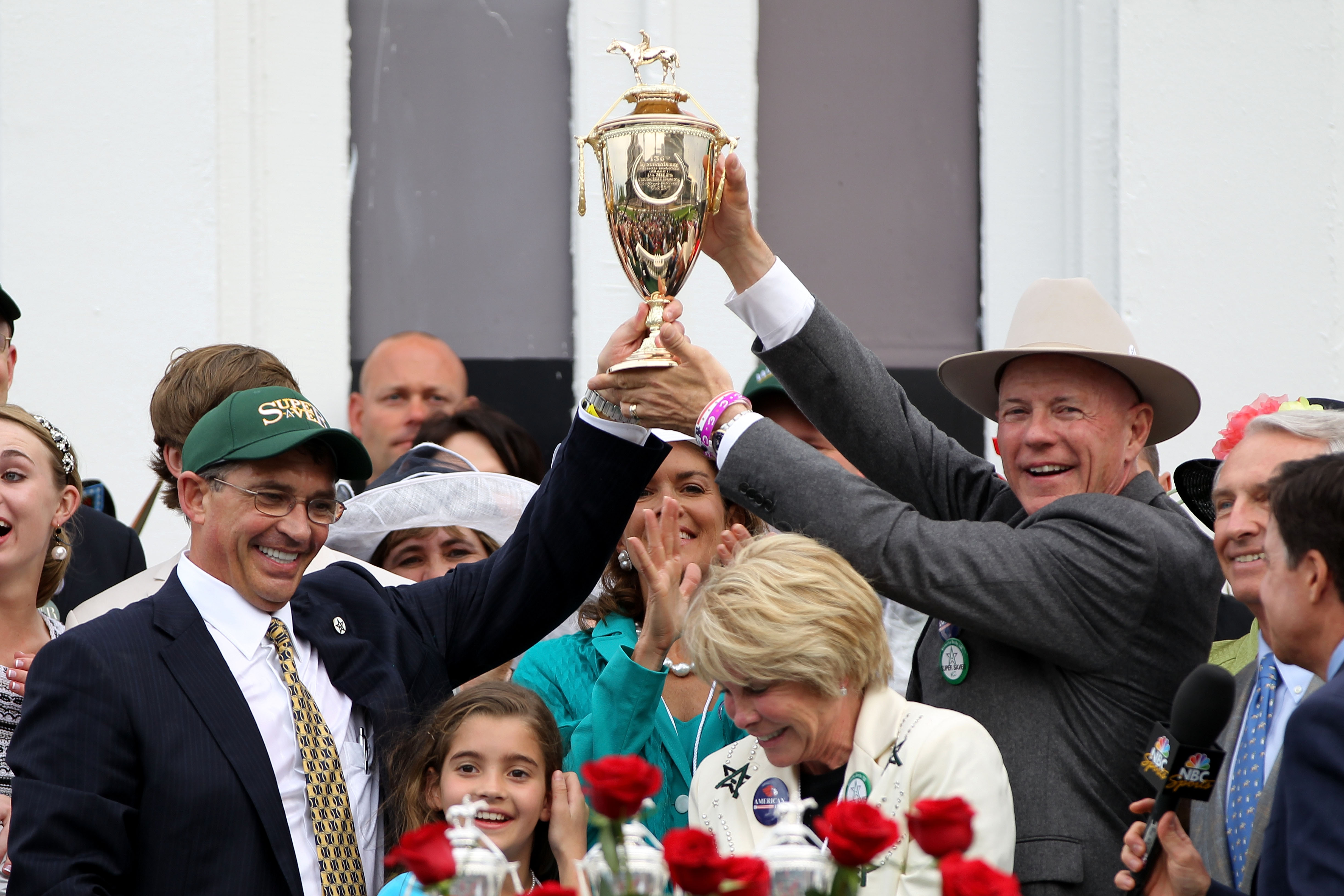 Kenny Troutt and Bill Casner holding their trophy in the winners' circle on May 1, 2010, in Kentucky | Source: Getty Images