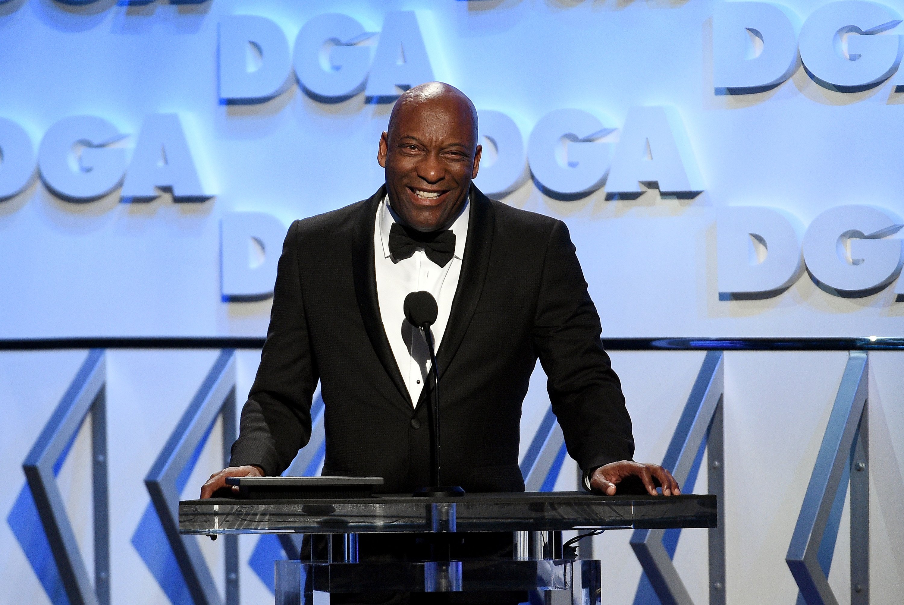 John Singleton speaking onstage during the 70th Annual Directors Guild Of America Awards in California on Feb. 3, 2018. | Photo: Getty Images