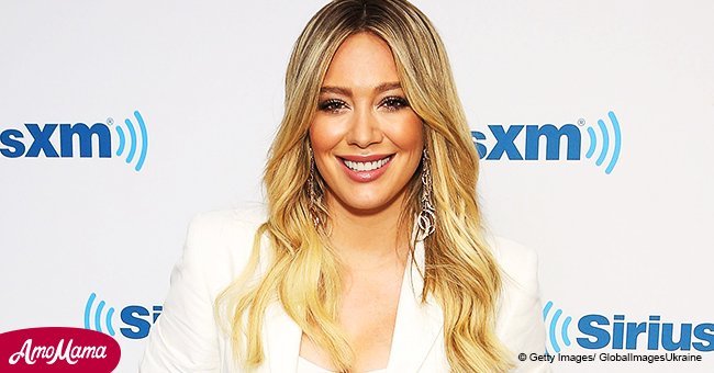 Hilary Duff shares a touching photo with her older sister as she cradles her enormous baby bump