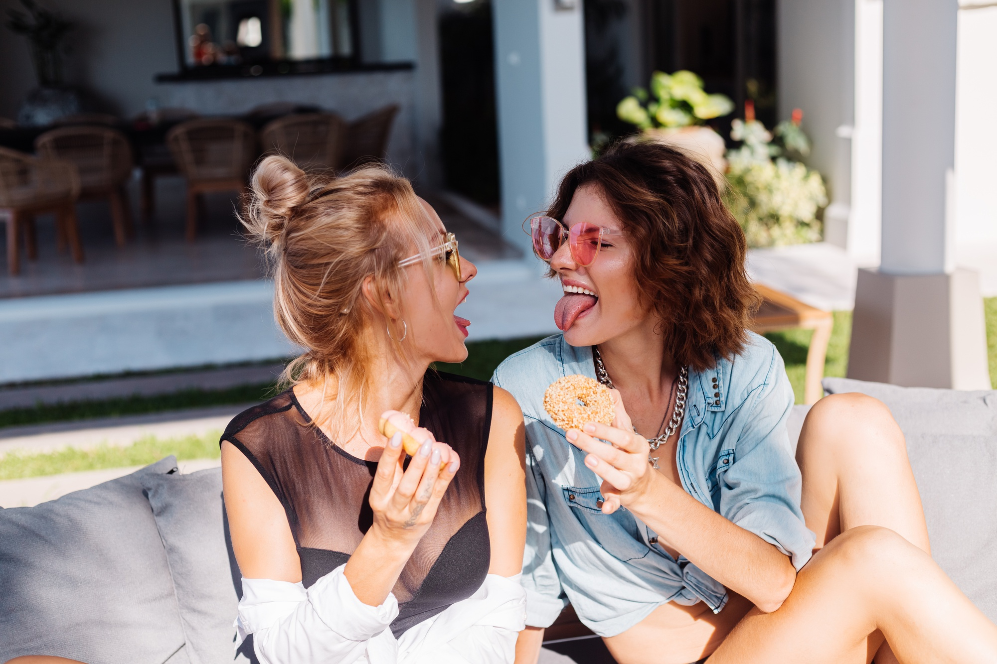 Two women enjoying donuts and having fun | Source: Freepik