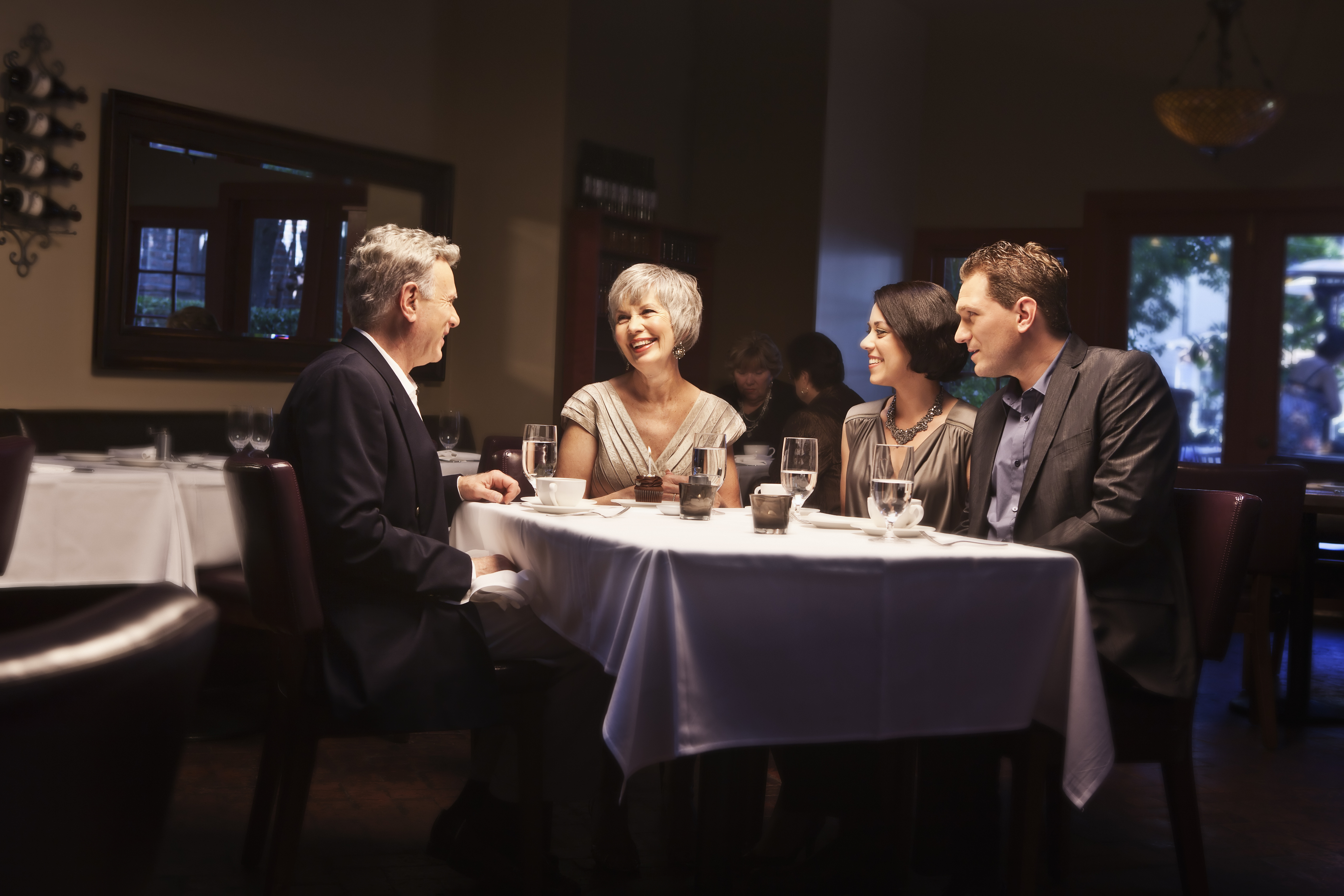 A couple having dinner with their parents | Source: Getty Images