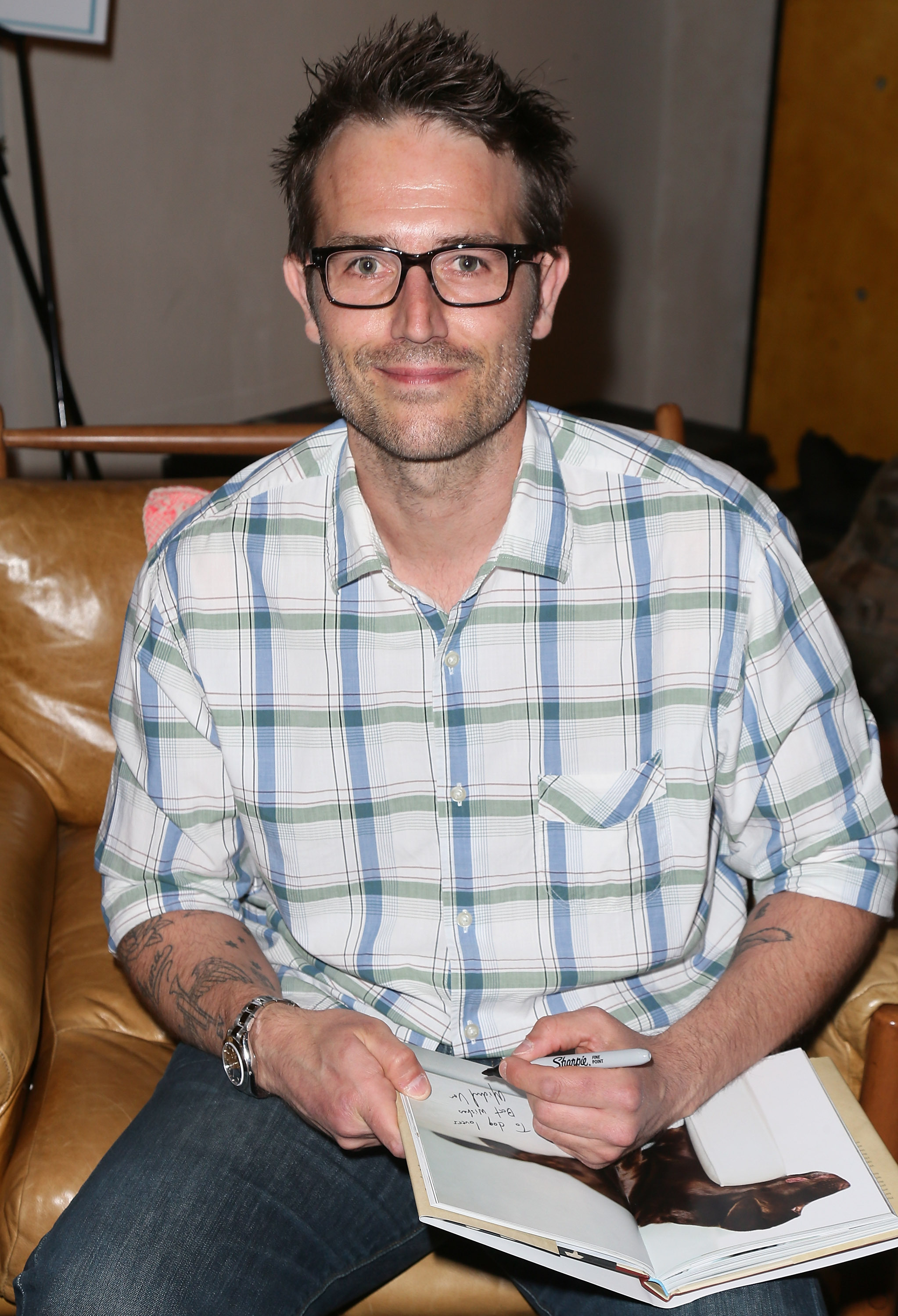 Michael Vartan poses at a book signing for "A Letter to My Dog" in Beverly Hills. Wearing a plaid shirt and signature glasses, he sports a casual look that reflected his growing focus on personal passions beyond acting.
