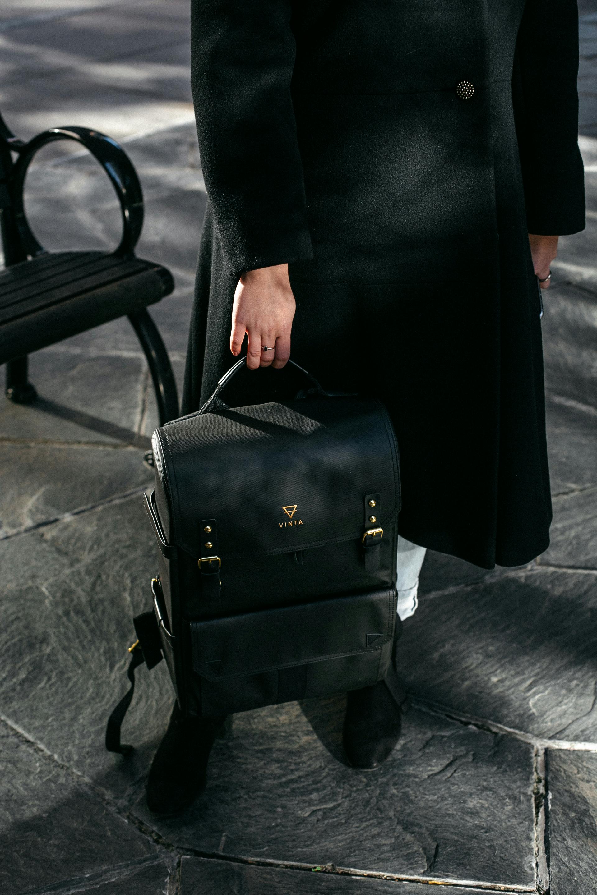 A woman holding a backpack | Source: Pexels