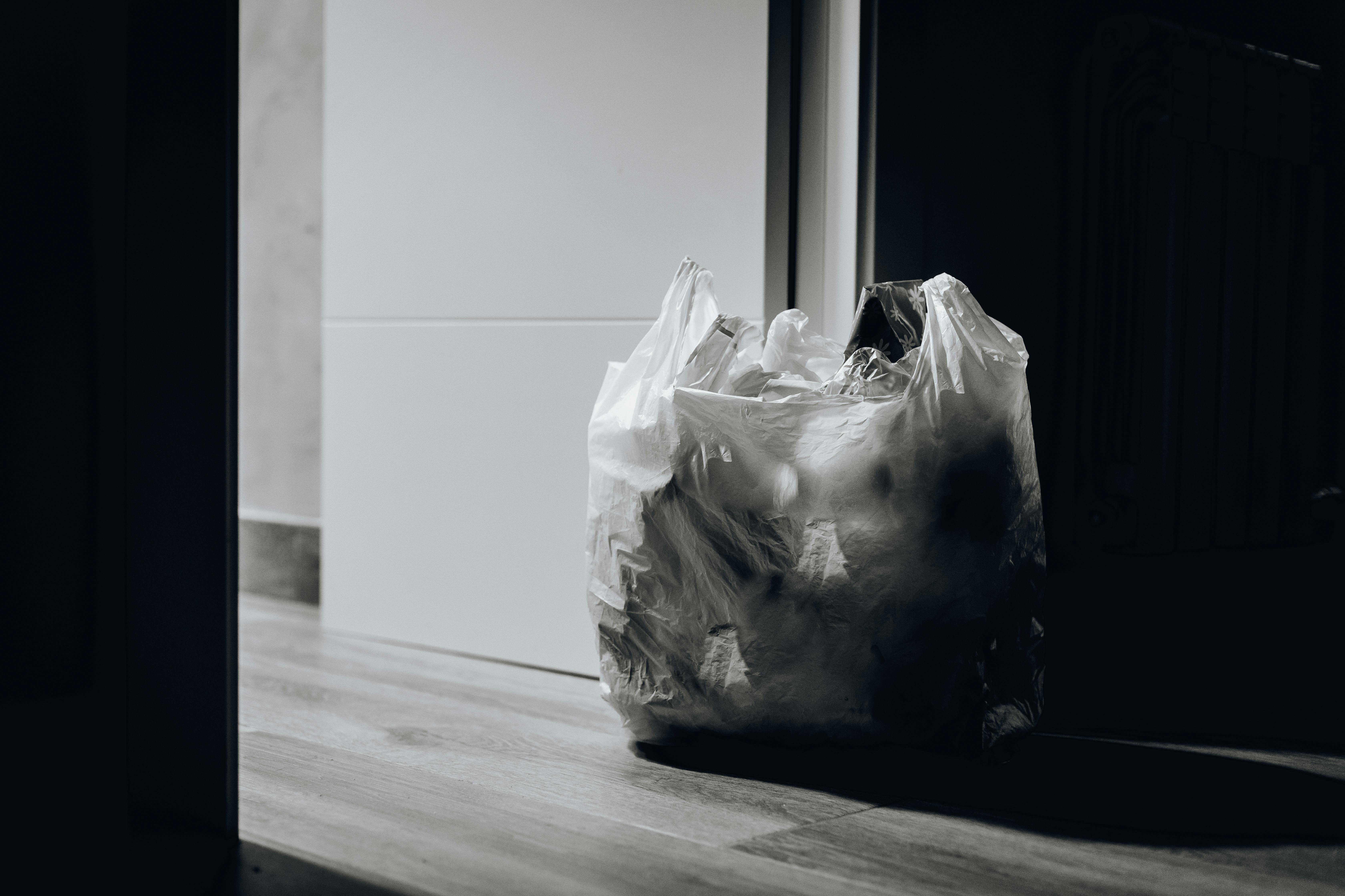 A bag of trash near a door | Source: Pexels