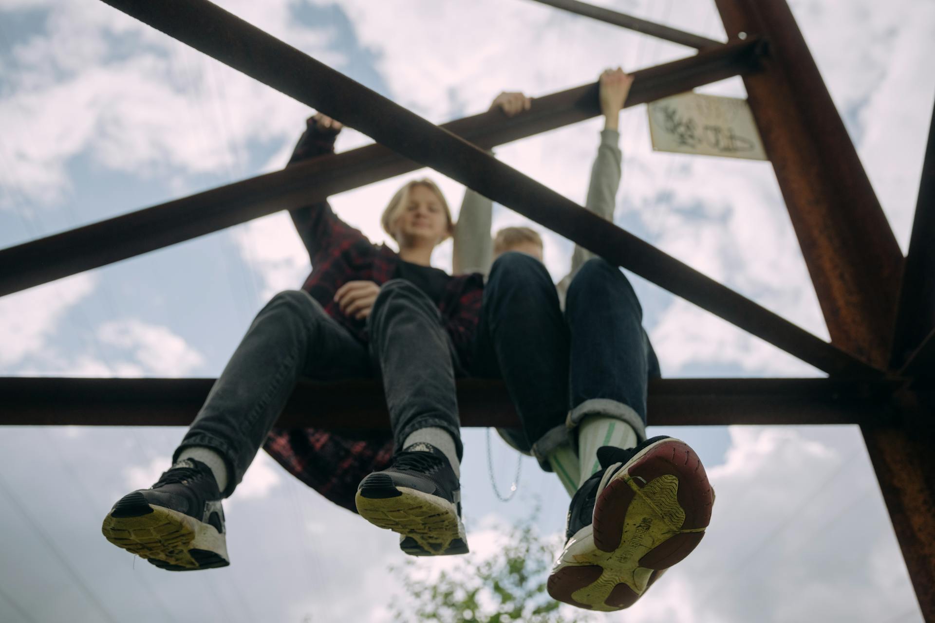 Teenage boys sitting on beams | Source: Pexels
