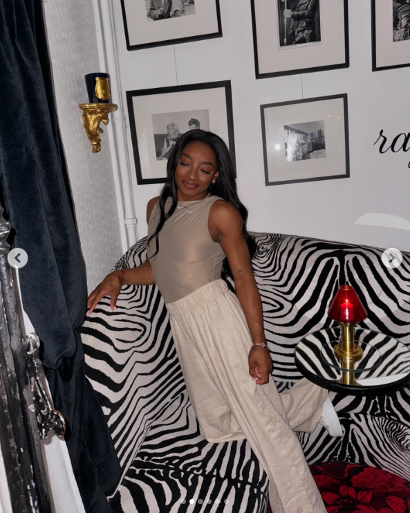 Simone Biles poses with her eyes close on a Zebra-printed couch in Paris, France, posted in August 2024 | Source: Instagram.com/simonebiles