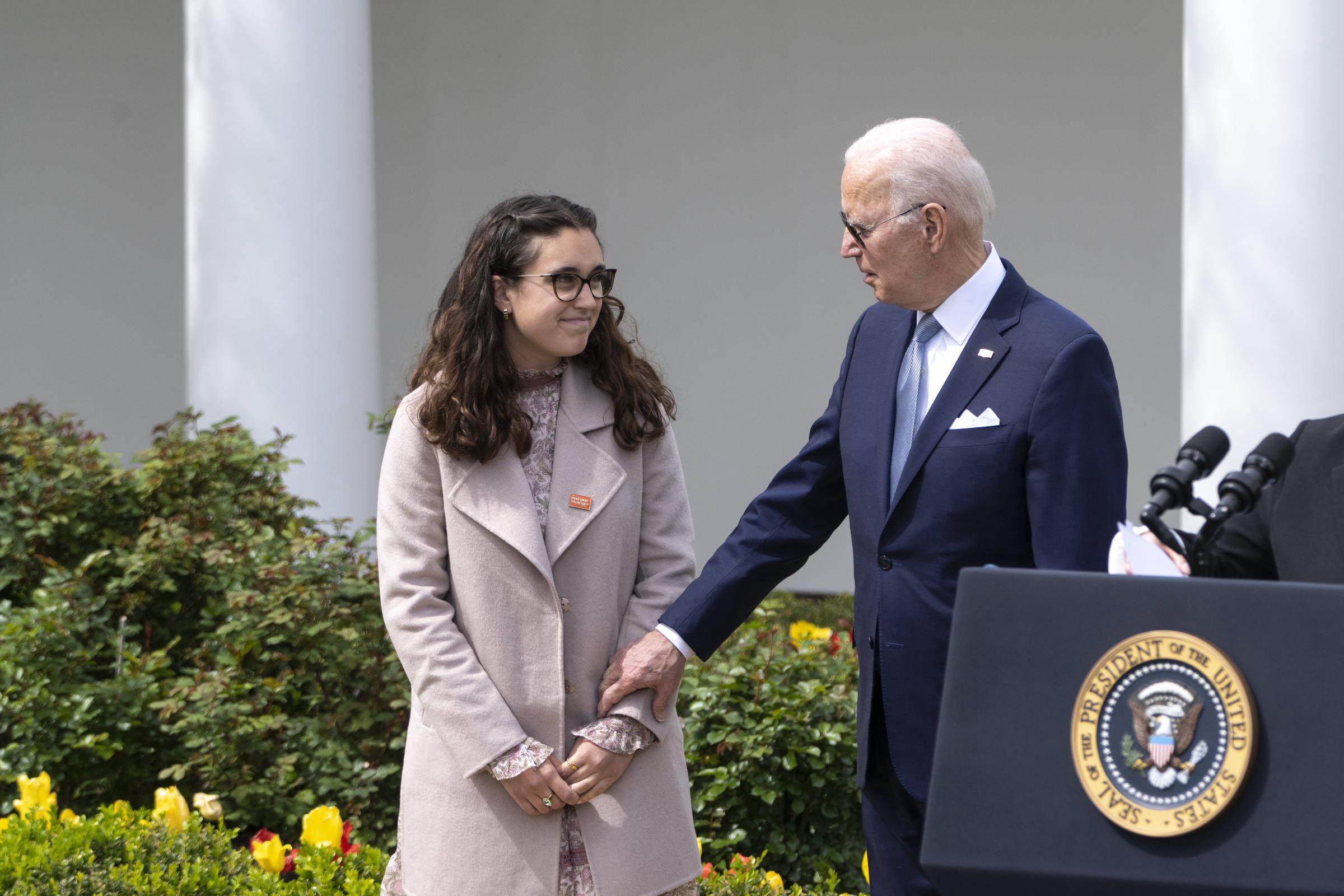 Then-President Joe Biden talks with Mia Tretta, a Saugus High School shooting survivor, during an event about gun violence in the Rose Garden of the White House on April 11, 2022, in Washington, DC | Source: Getty Images