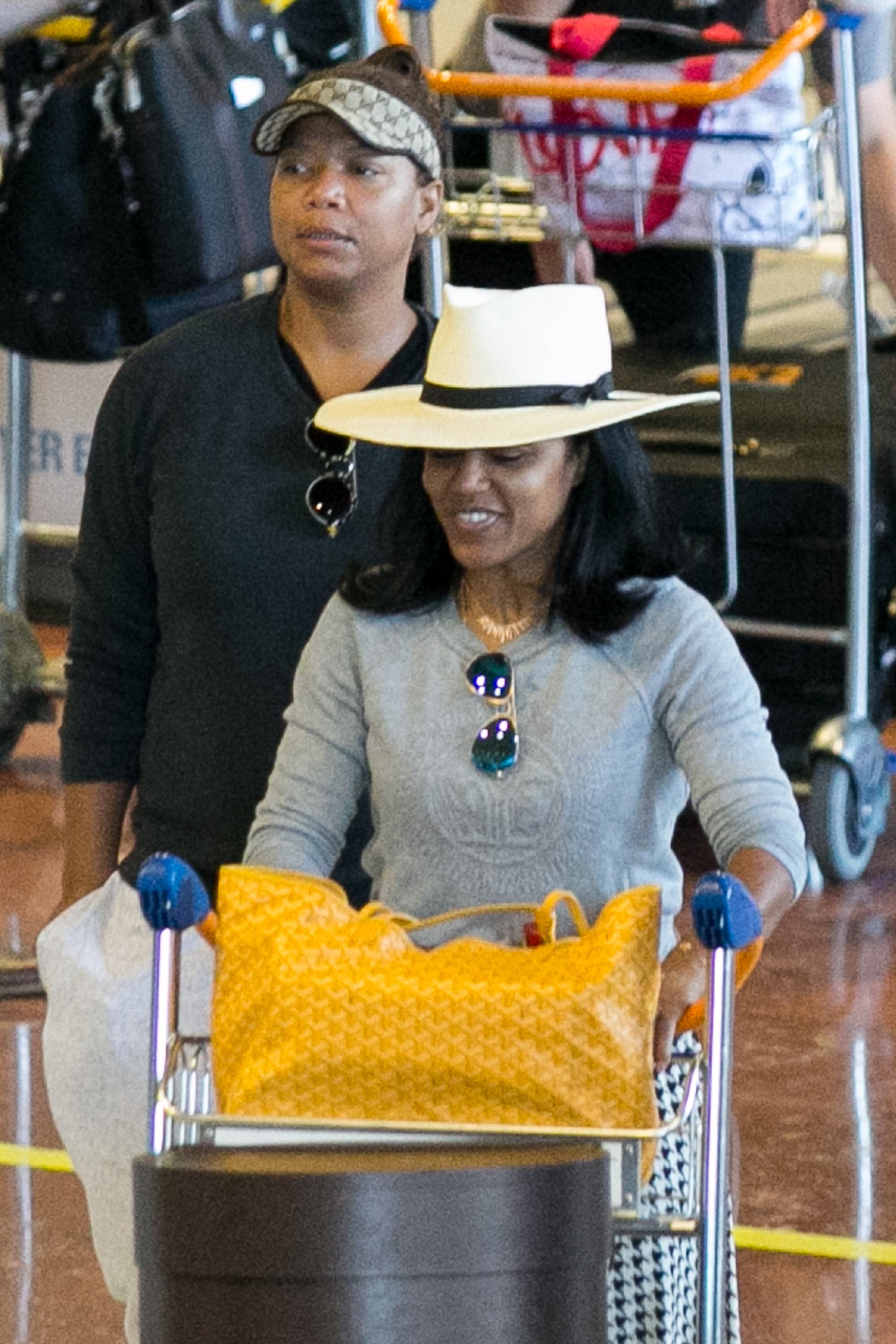 Queen Latifah and Eboni Nichols are seen at Charles-de-Gaulle airport in Paris, France on July 6, 2015. | Source: Getty Images