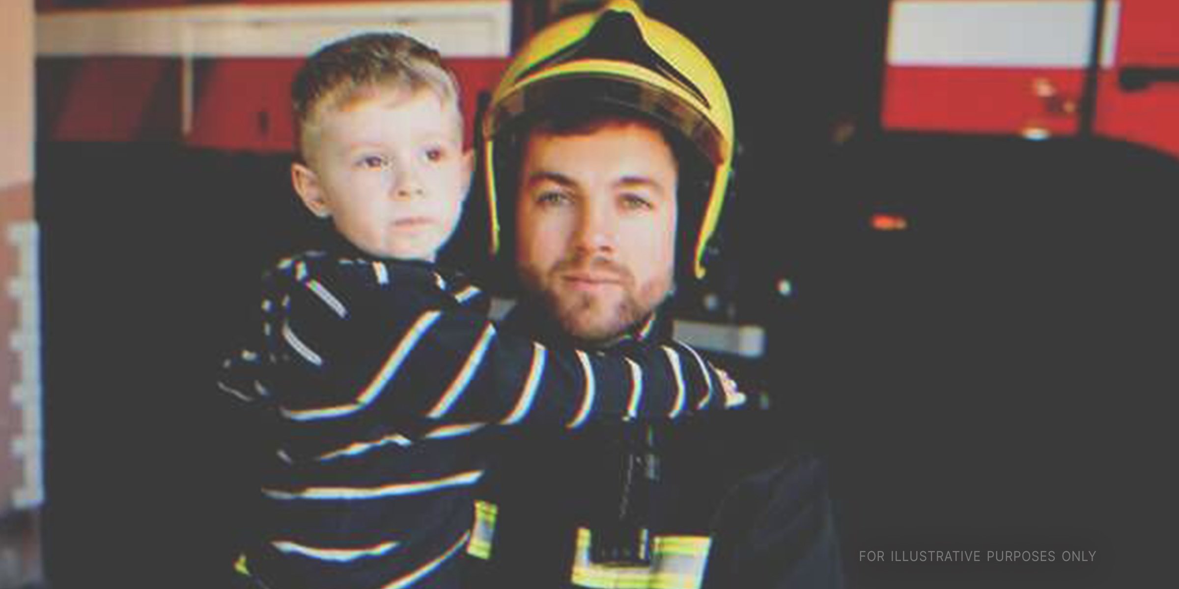 Fireman hugging a boy. | Source: Shutterstock
