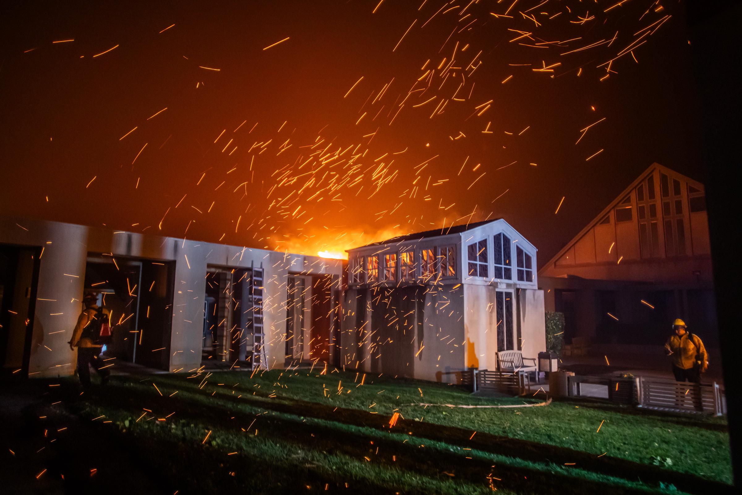 A firefighter watching the flames from the Palisades Fire burning in front of the Pacific Palisades Presbyterian Church during a powerful windstorm on January 8, 2025, in Los Angeles, California. | Source: Getty Images