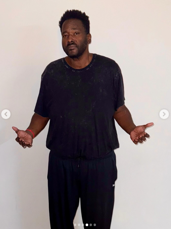 Quinton Aaron stands facing forward in workout clothes during his weight-loss transformation | Source: Instagram/officialquintonaaron