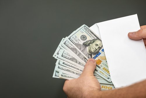 Cash in an envelope. | Source: Shutterstock.