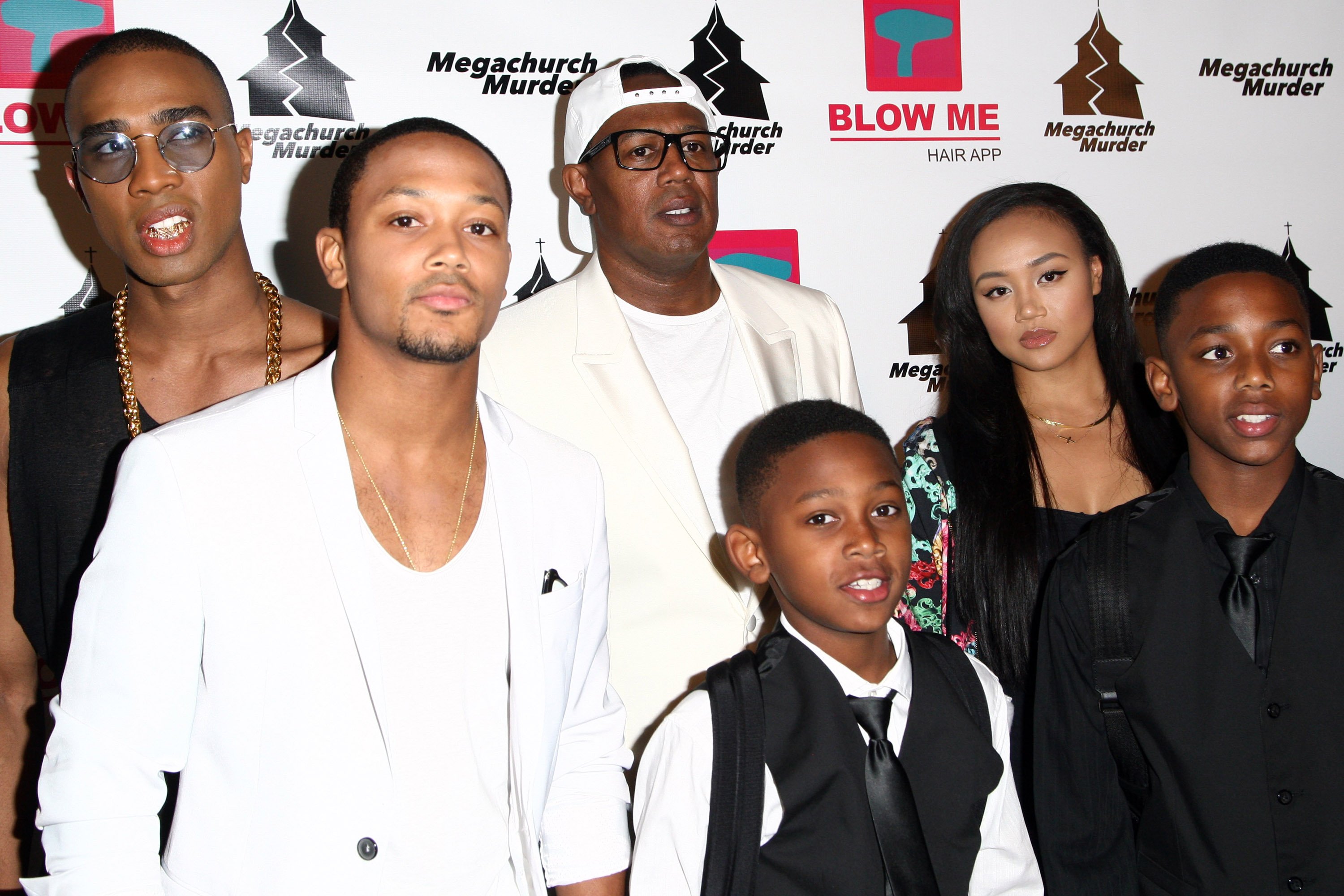 Rappers Romeo Miller aka Lil’ Romeo (L), Master P (C) and family attend the "Megachurch Murder" premiere screening held at the Harmony Gold Theatre on January 29, 2015, in Los Angeles, California. | Source: Getty Images