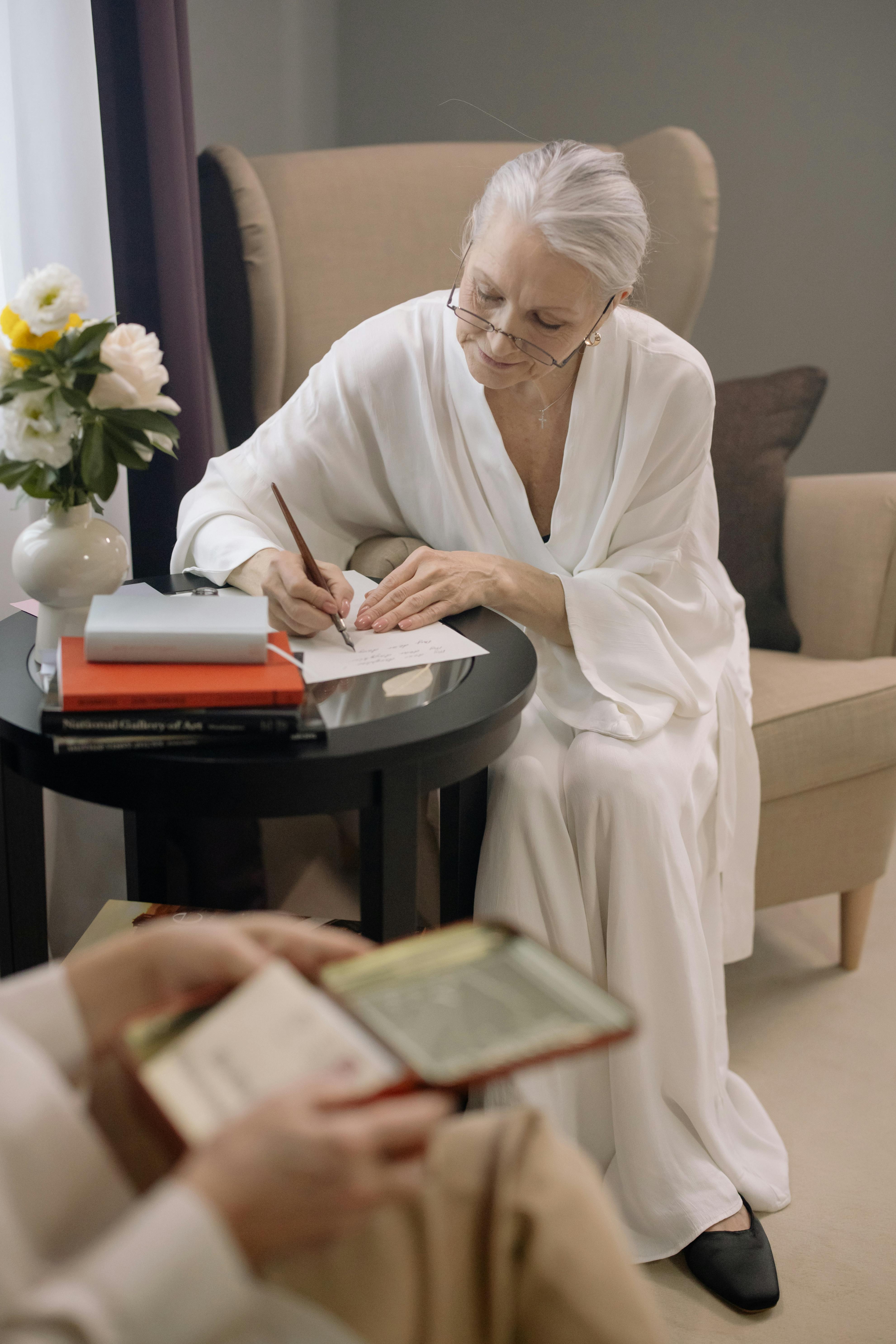 Elderly woman writes a letter | Source: Pexels