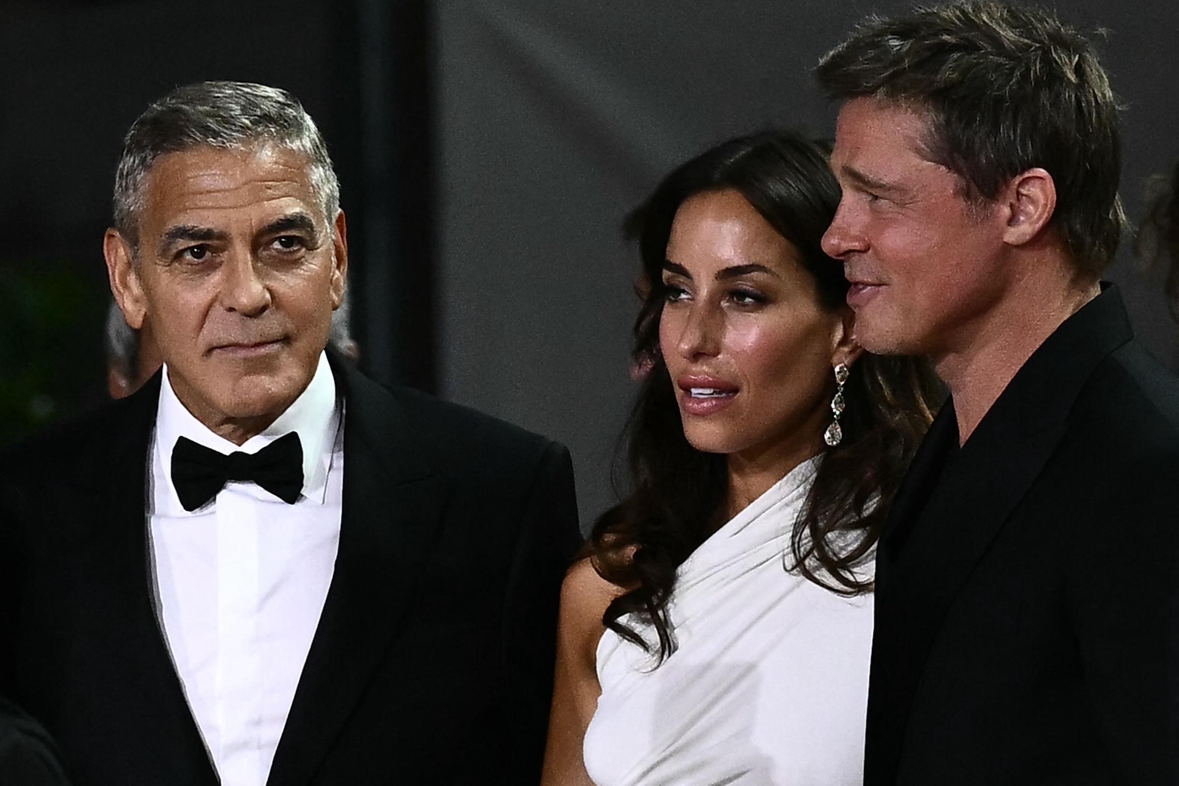 George Clooney, Inés-Olivia de Ramon, and Brad Pitt at the "Wolfs" red carpet during the 81st Venice International Film Festival on September 1, 2024, in Italy. | Source: Getty Images