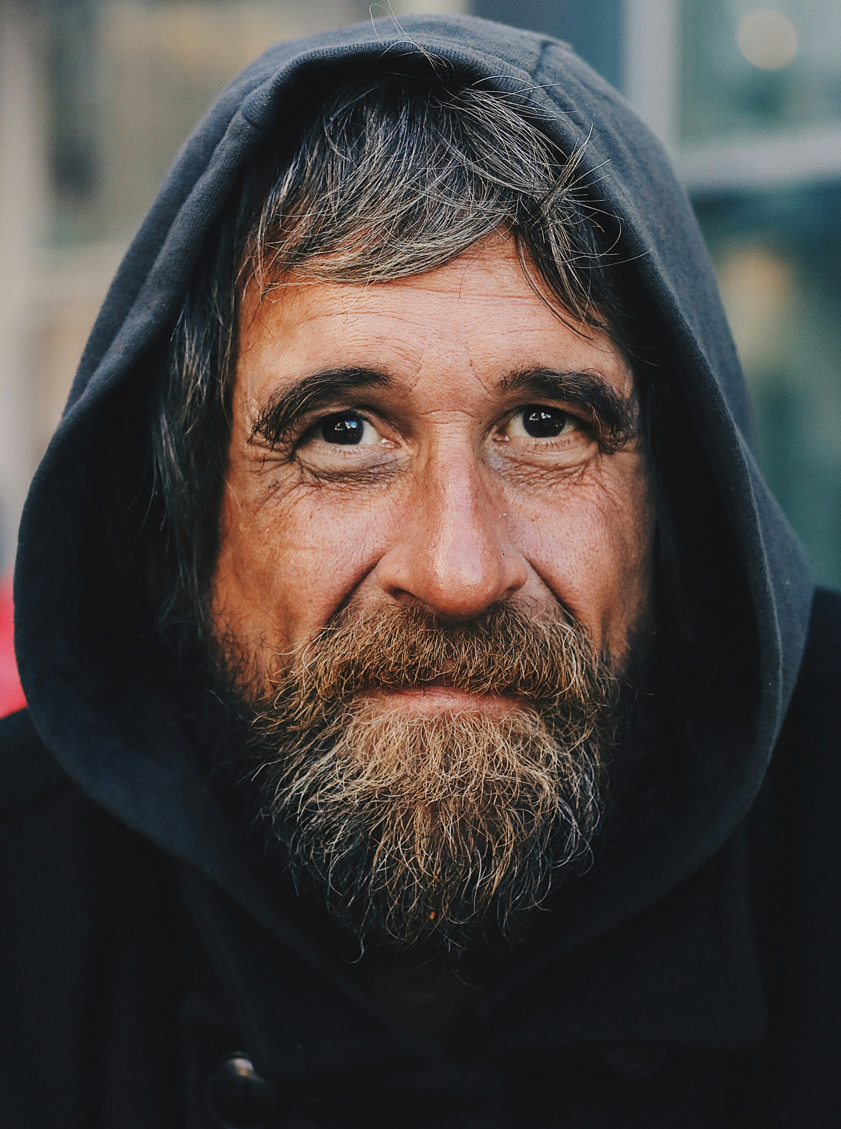 A man smiling shyly | Source: Unsplash