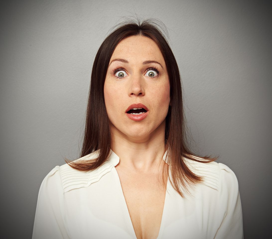 A woman looks shocked at the camera. | Source: Shutterstock