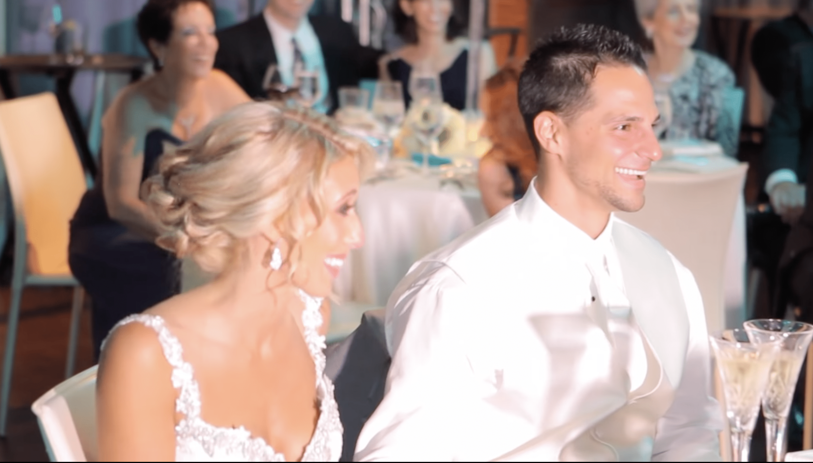 Nick del Bono and Lauren Elise laugh as their son, Vincent, gives his best man speech. | Photo: YouTube.com/Ashe Productions 