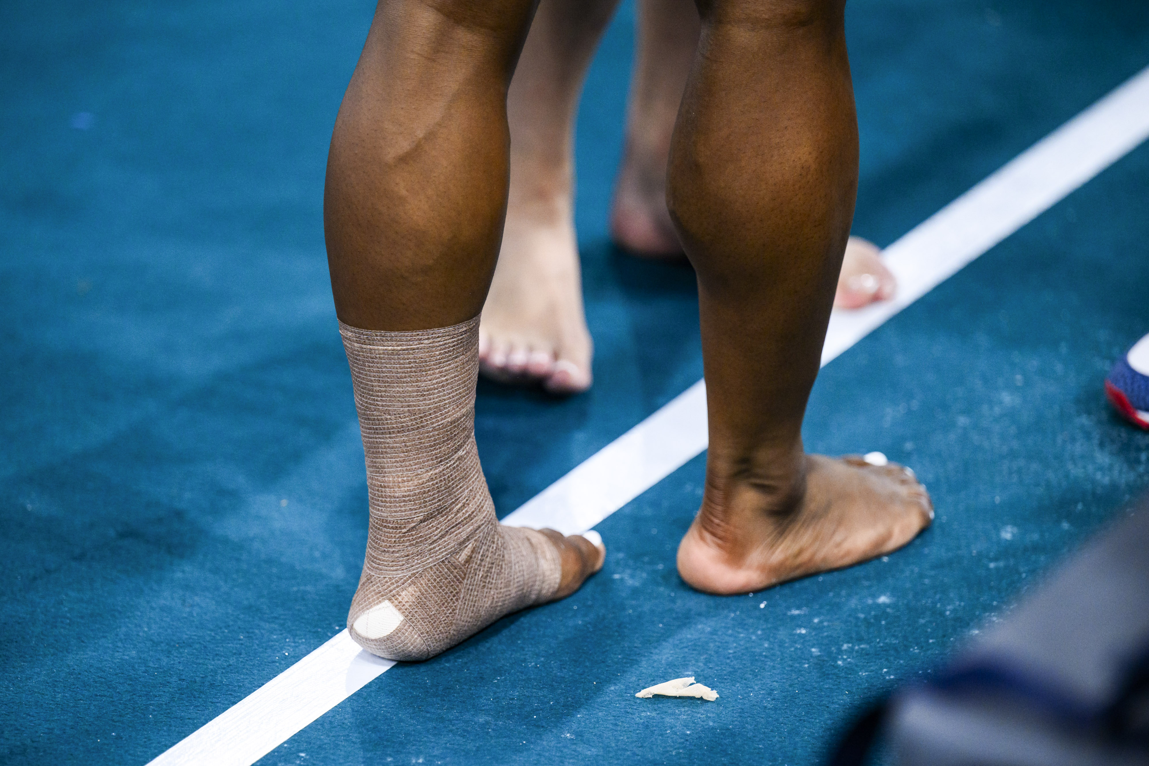 A close-up of Simone Biles' bandaged ankle and calf during the Artistic Gymnastics Women's Qualification in Paris, France on July 28, 2024 | Source: Getty Images