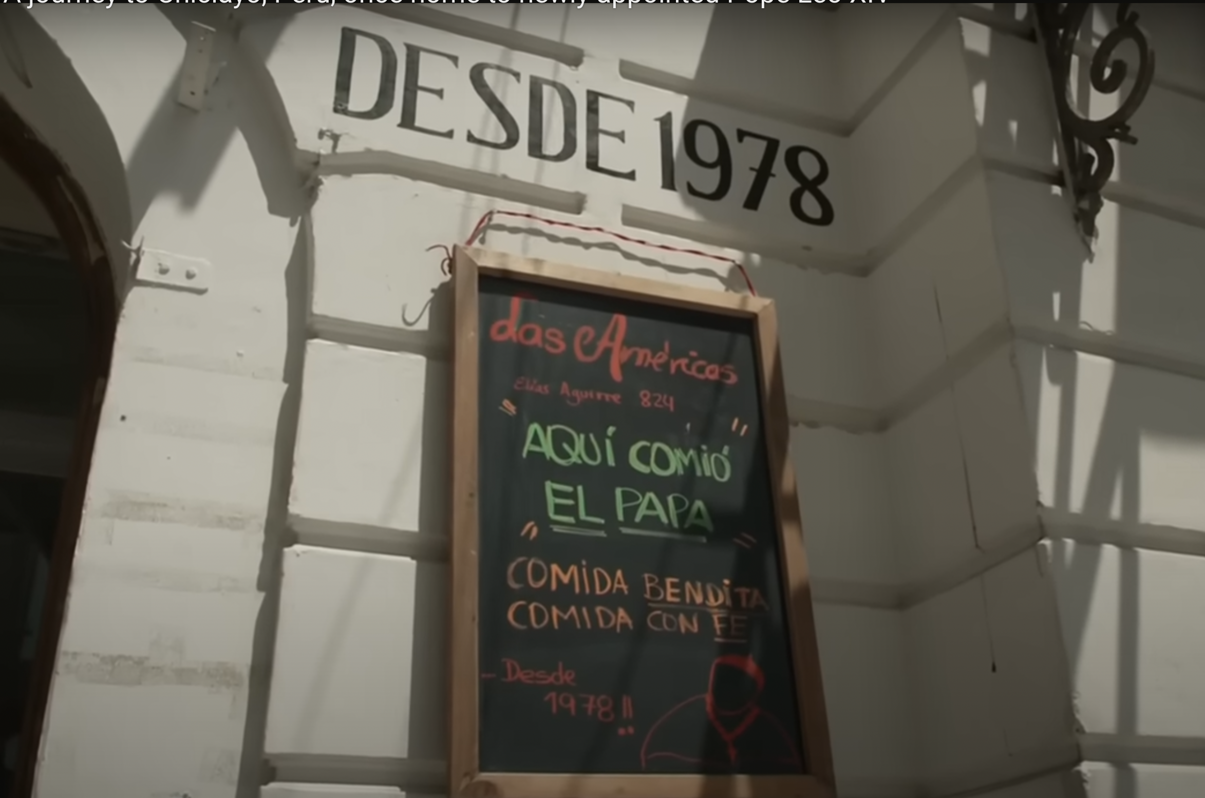 A screenshot of a hand-lettered chalkboard outside Las Américas restaurant from a video dated May 13, 2025. | Source: YouTube/ABC News