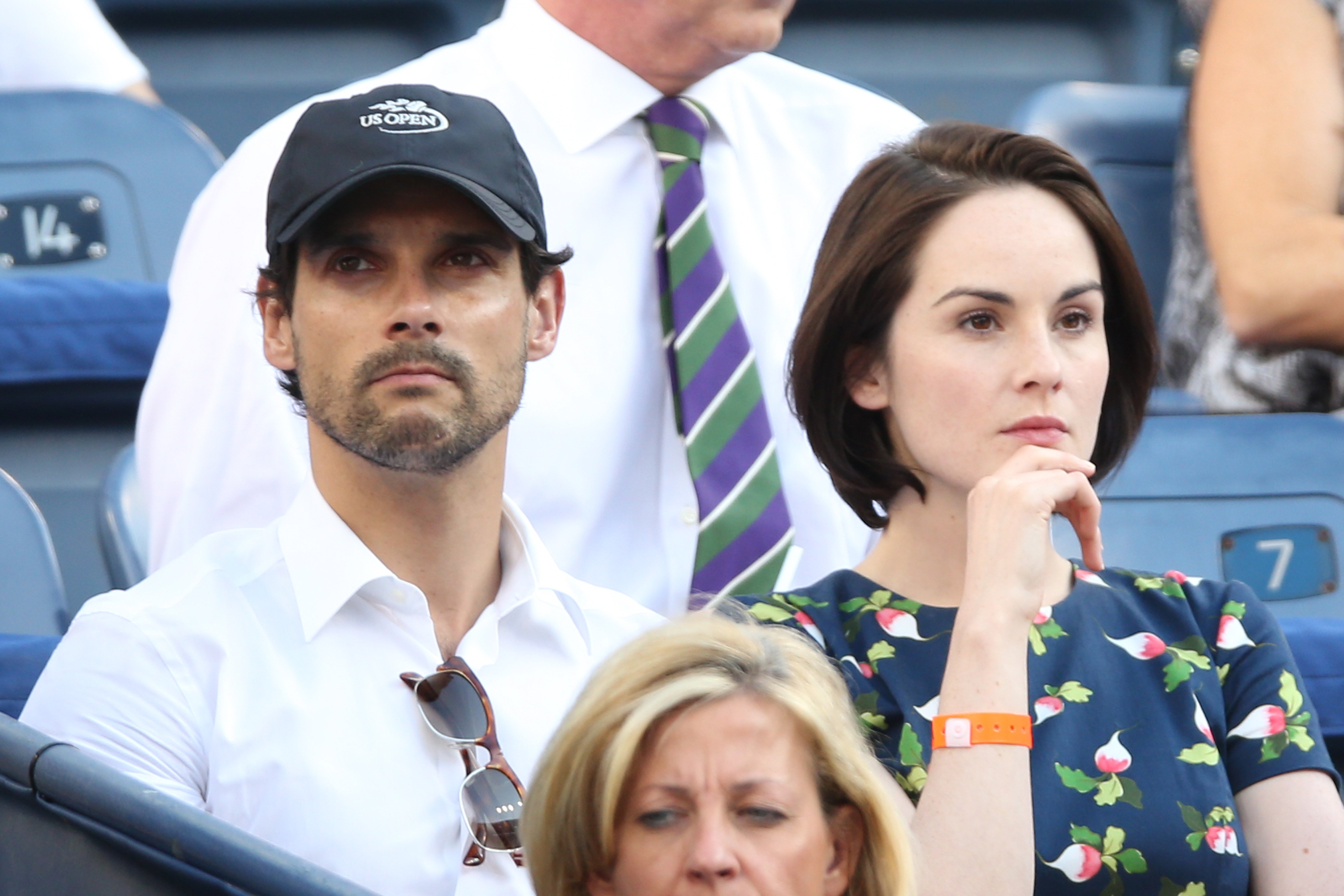 John Dineen and Michelle Dockery watch the women's singles semifinal match between Serena Williams of United States of America and Na Li of China on Day Twelve of the 2013 US Open in Queens, New York. | Source: Getty Images