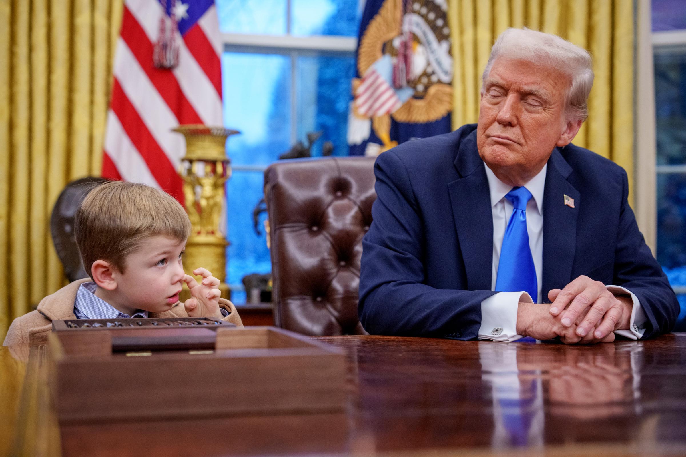 Donald Trump looking at X Æ A-Xii. | Source: Getty images