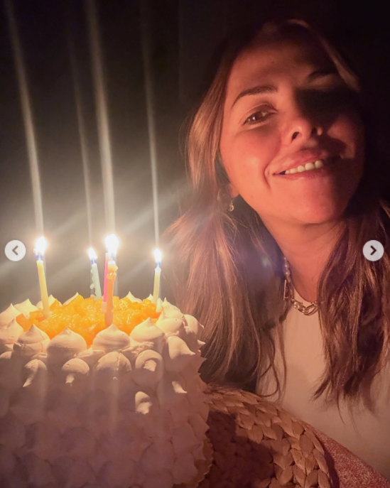 Yanina smiles beside her birthday cake as candles glow in the dimly lit room. Lucas Trejo shared the celebration with a heartfelt message wishing her another year of blessings. | Source: Instagram/lucastrejo_lt