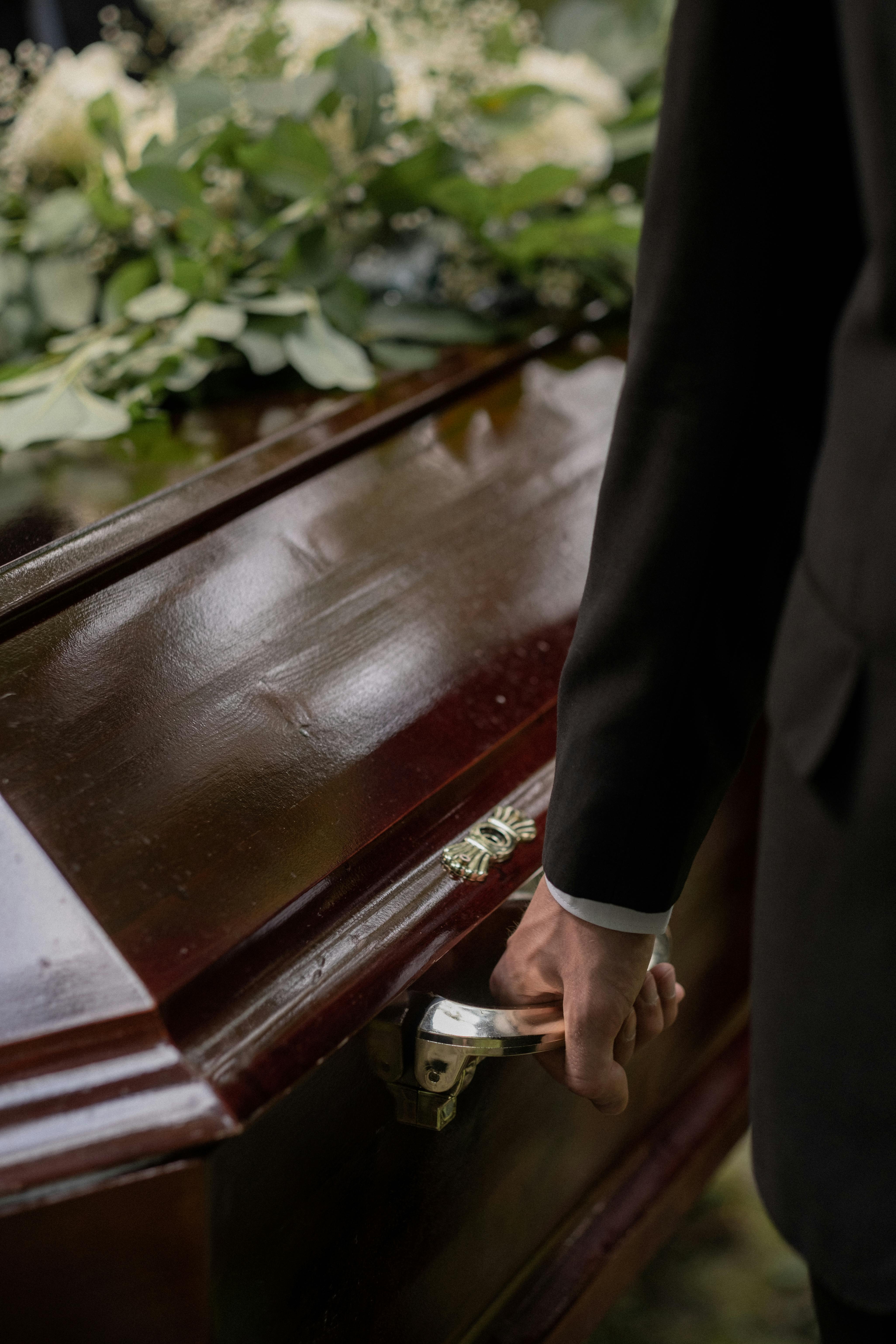 A close-up of a man carrying a coffin | Source: Pexels