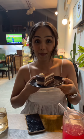 Radhika Yadav showing off a cake, from a clip posted by her best friend, Himaanshika Singh Rajput, on July 12, 2025 | Source: Instagram/himaanshika