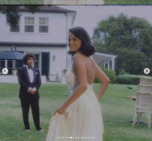 Selena Gomez turning to smile at the camera while Benny Blanco stands behind her. | Source: Instagram/selenagomez