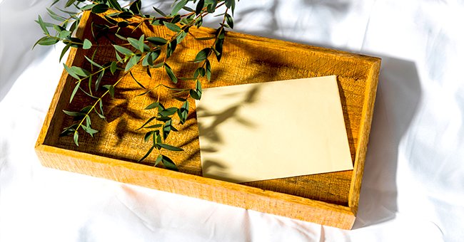 A envelope lies in a wooden box waiting to be opened. | Photo: Shutterstock