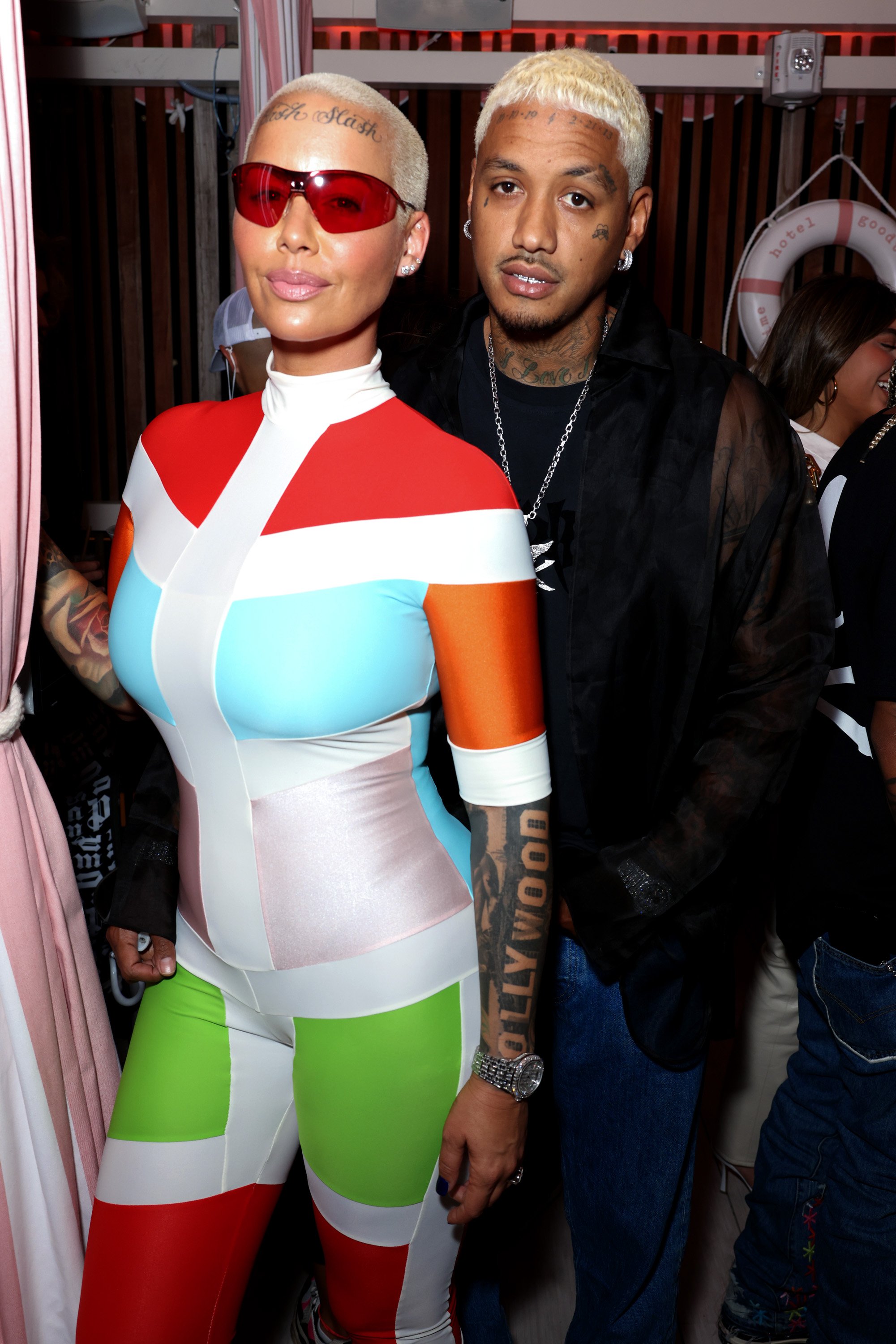 Amber Rose and Alexander Edwards pose for a photo at the "A Night From Rio" Art Exhibition & Single Release Celebration at The Pool at Strawberry Moon on April 30, 2021, in Miami Beach | Source: Getty Images